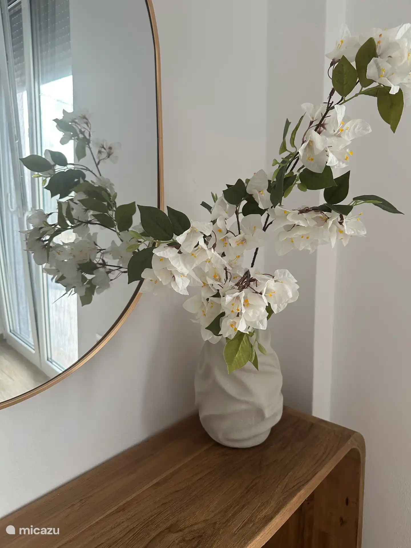 The beautiful flowers on the dressing table.
