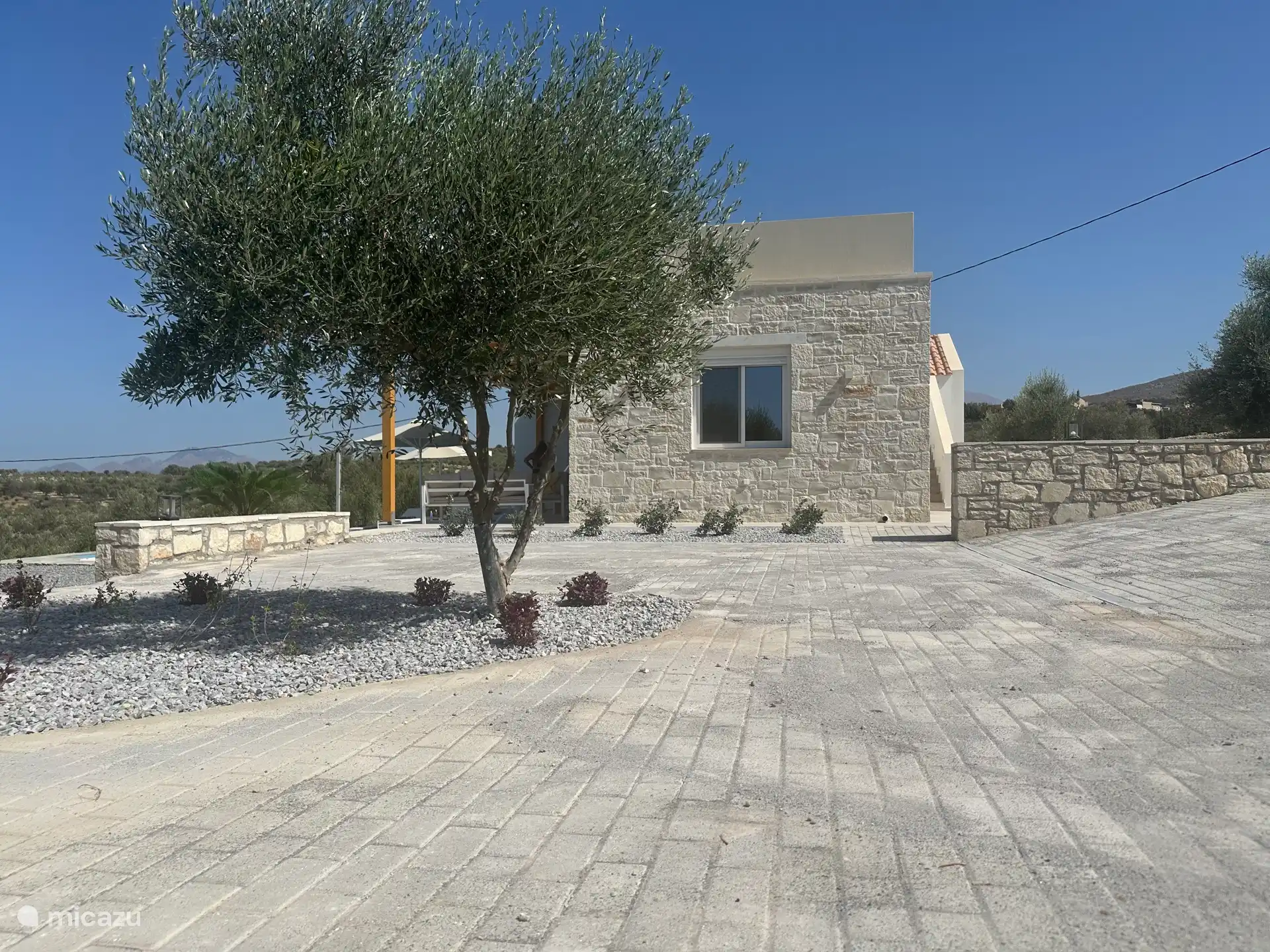 The parking lot next to the villa.