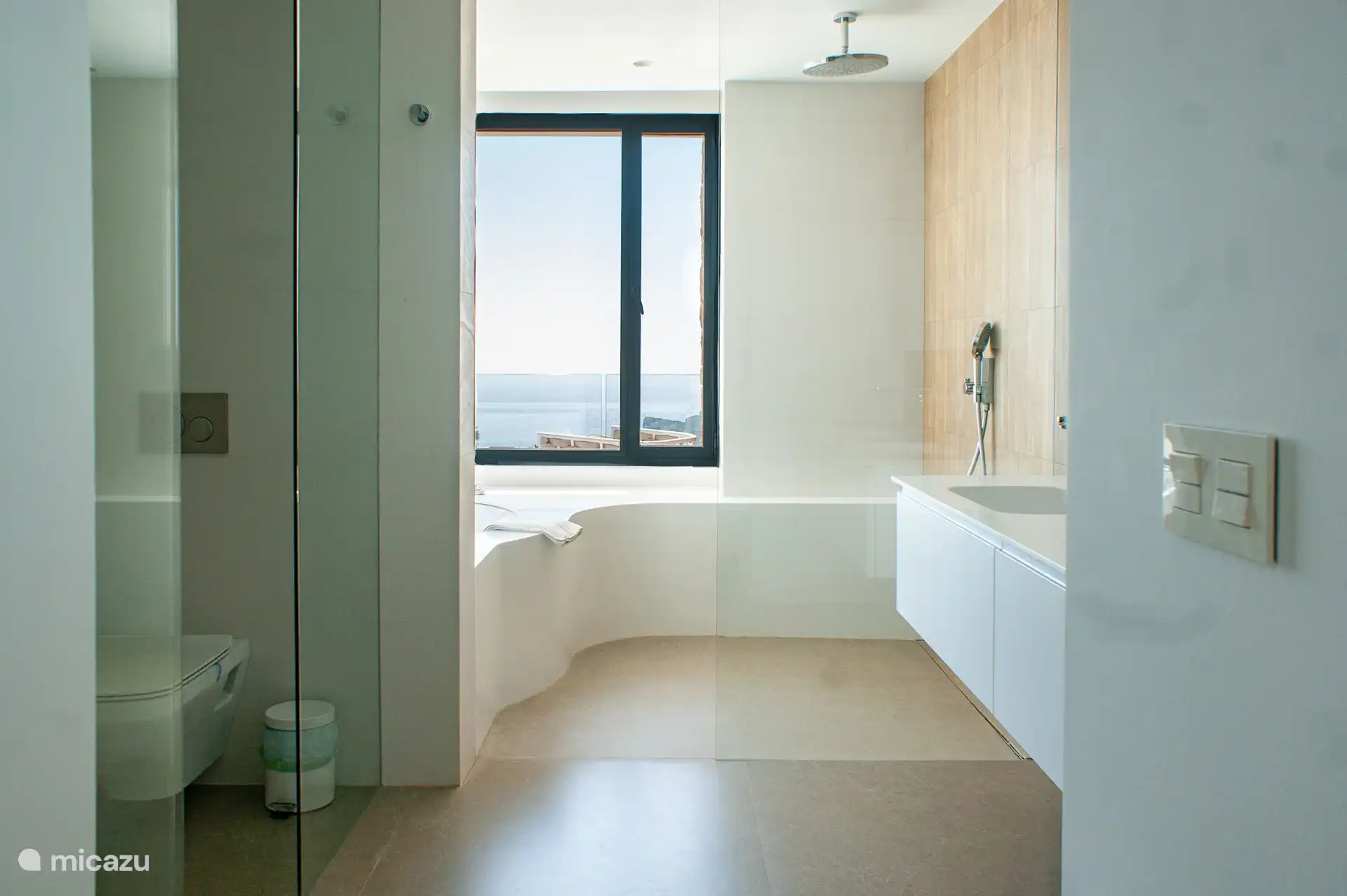 Badezimmer mit zwei Waschbecken, Toilette, begehbare Dusche, Badewanne und wunderschöner Aussicht