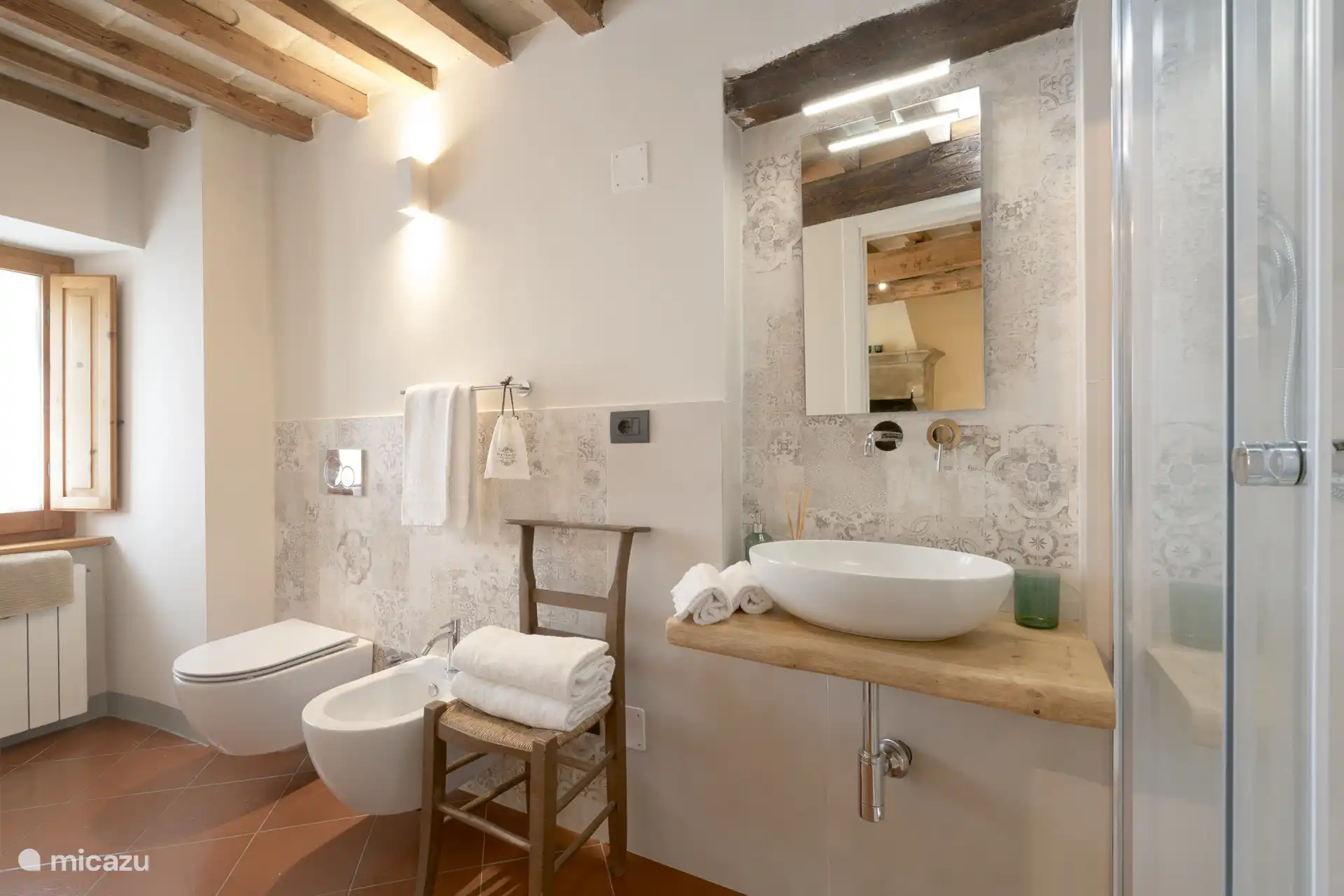 The en-suite bathroom of the room with a fireplace.
