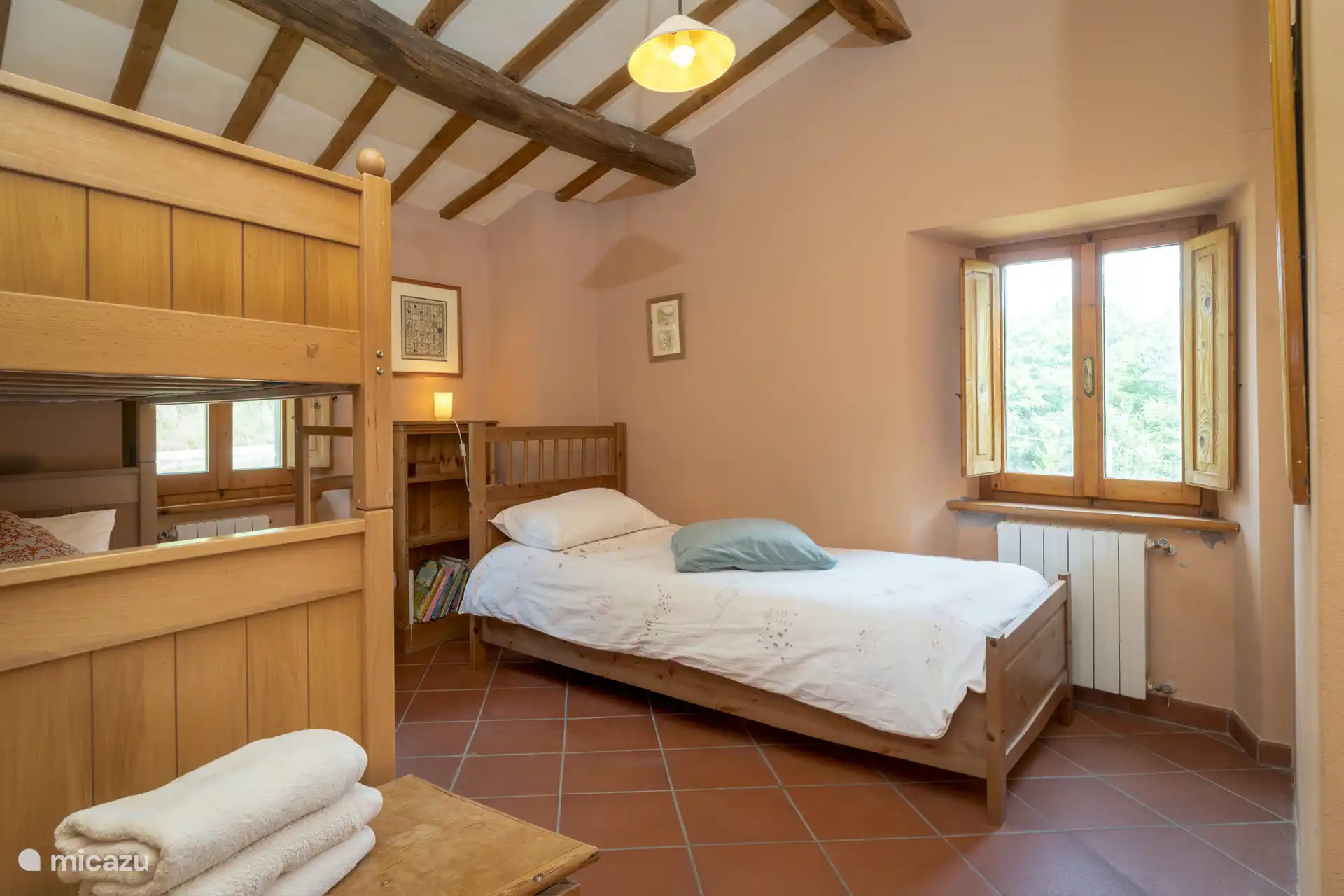 The room features a single bed and a bunk bed, ideal for kids.