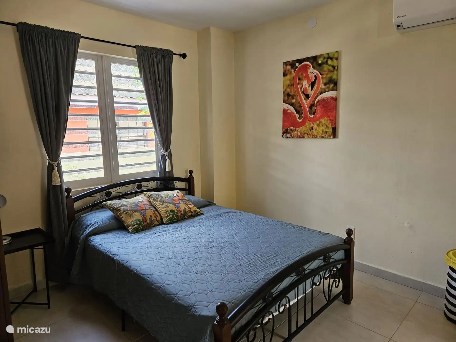 Dormitorio con una cómoda cama doble y aire acondicionado