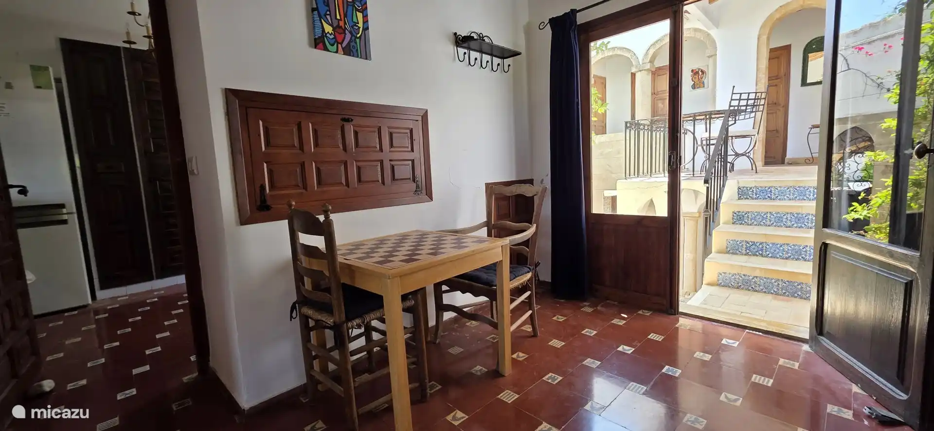 Dining room with authentic Spanish floor, chess table and passage to the patio
