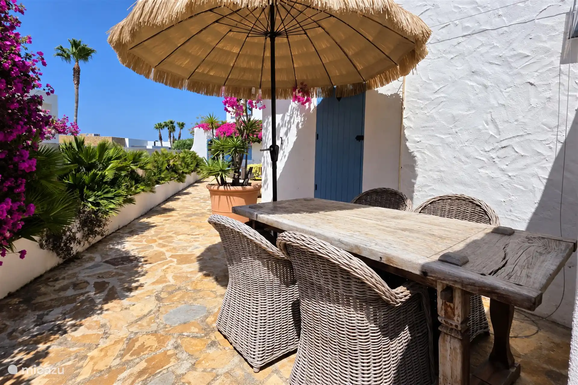Terrasse derrière la maison avec une table à manger. Un endroit calme pour se retirer et profiter de l’ambiance espagnole.