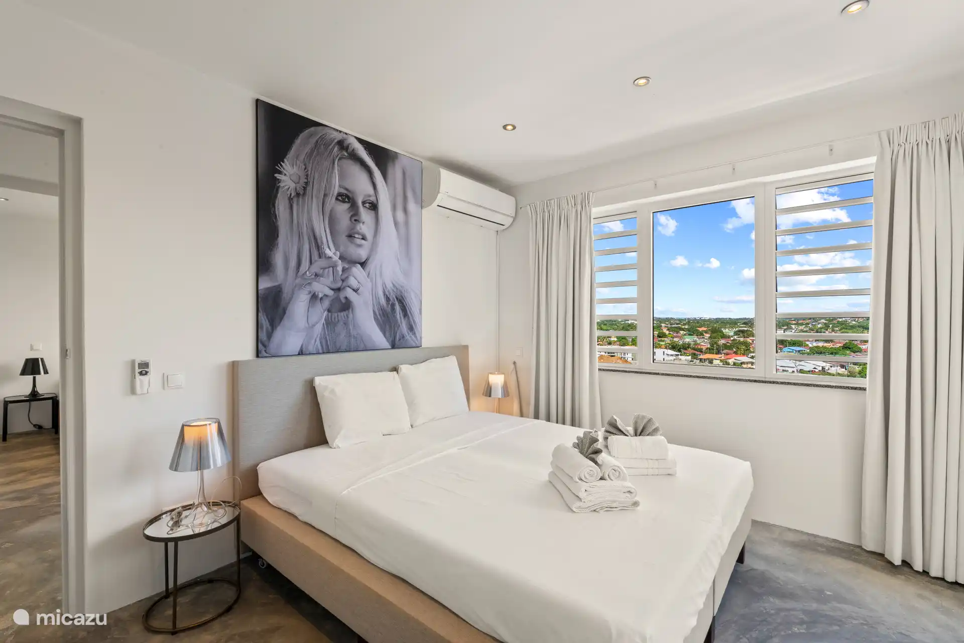 Bedroom 2 with AC and shared bathroom.