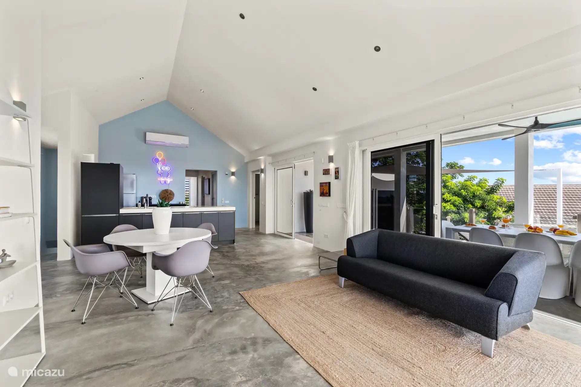 Thanks to the large sliding doors, the open-plan living room flows seamlessly into the outdoor area, providing the ultimate Caribbean living experience. 