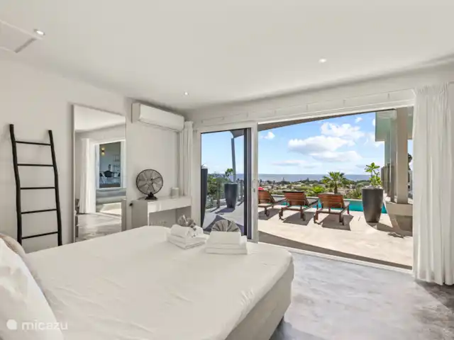 Artistieke Villa Scoop met zeezicht huren in Curaçao, Banda Ariba (oost), Bapor Kibra - villa De master bedroom heeft grote sliding deuren naar het pool deck.