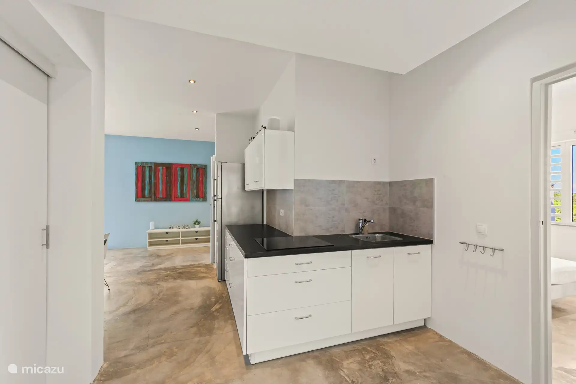 Kitchenette at the apartment with stove, refrigerator and freezer.