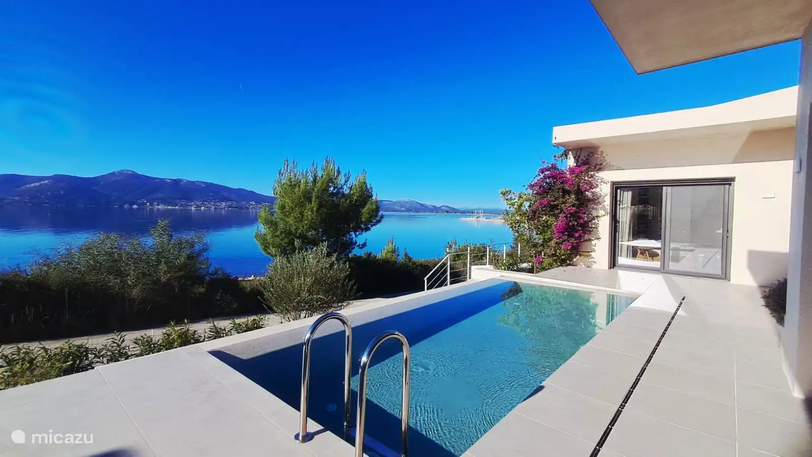 View of the sea, mountains and the harbour on the right corner