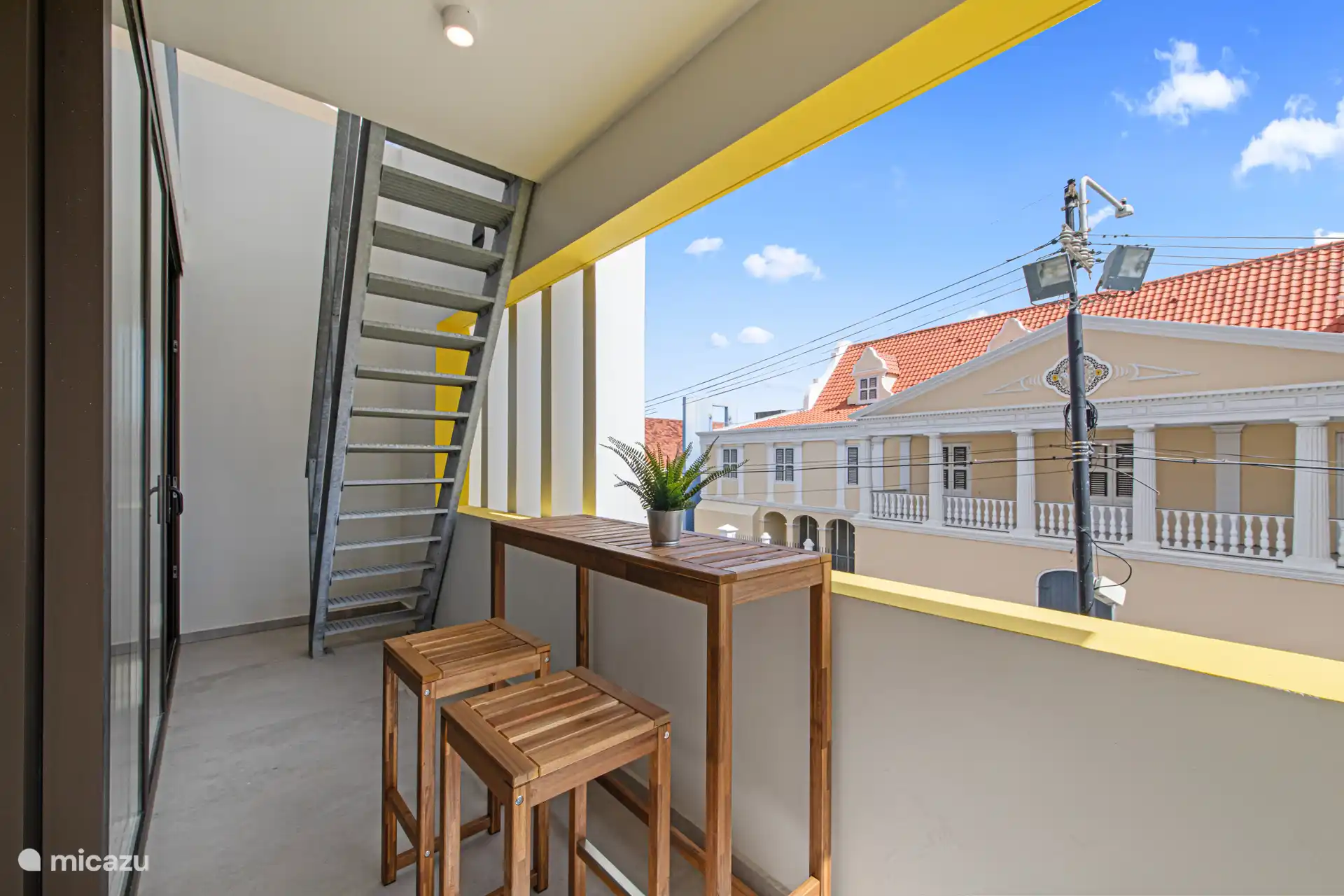 Neben dem Wohnzimmer befindet sich ein Balkon.