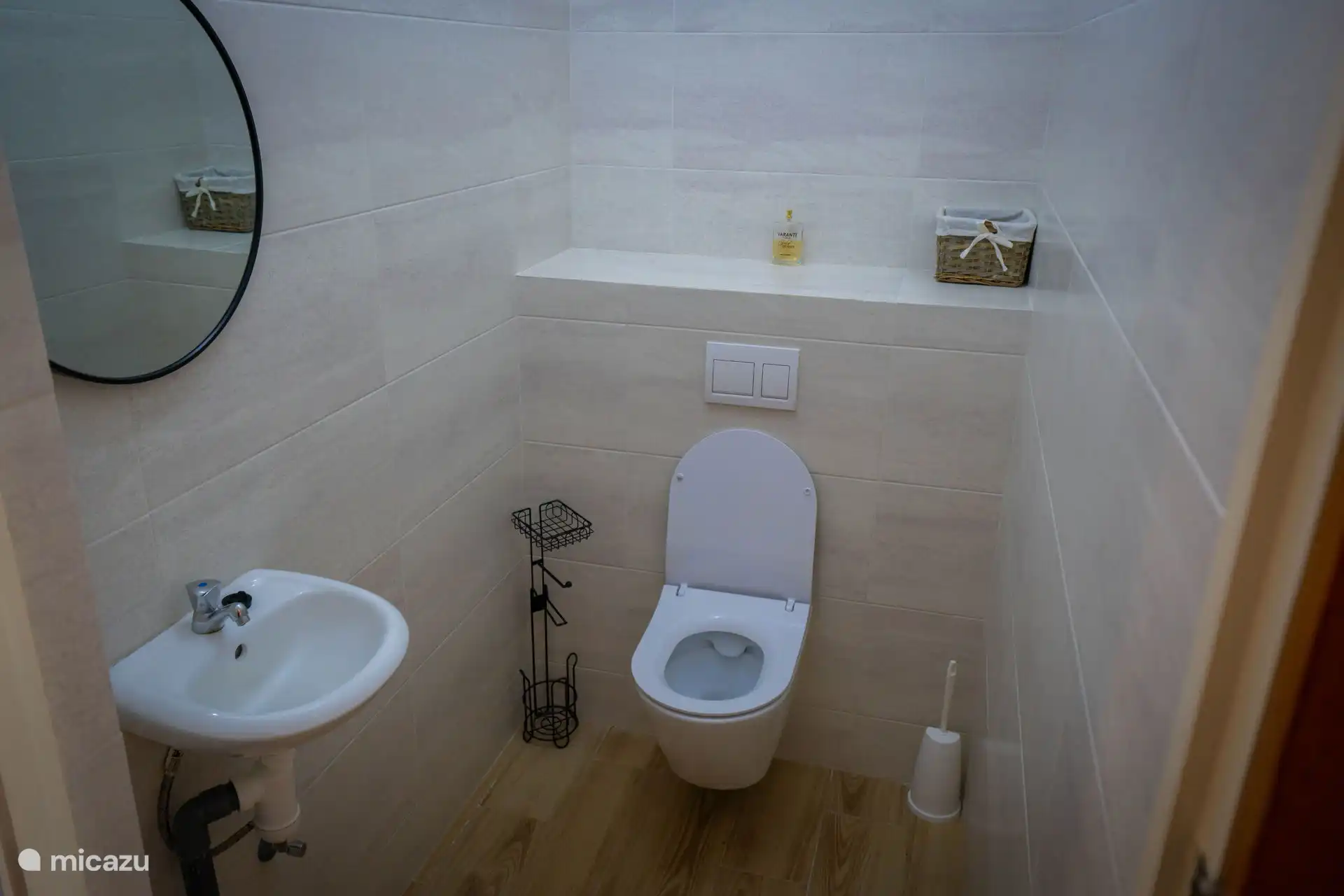 Separate toilet room with modern hanging toilet