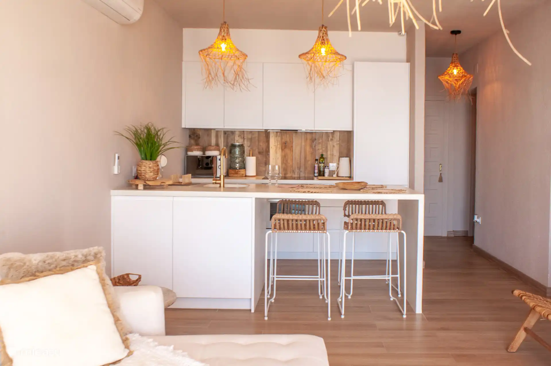 Kitchen with kitchen island and four bar chairs