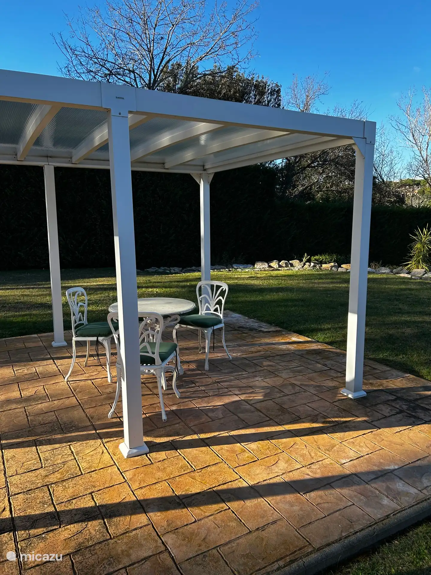 Covered pergola where there is a nice lounge sofa in the summer 