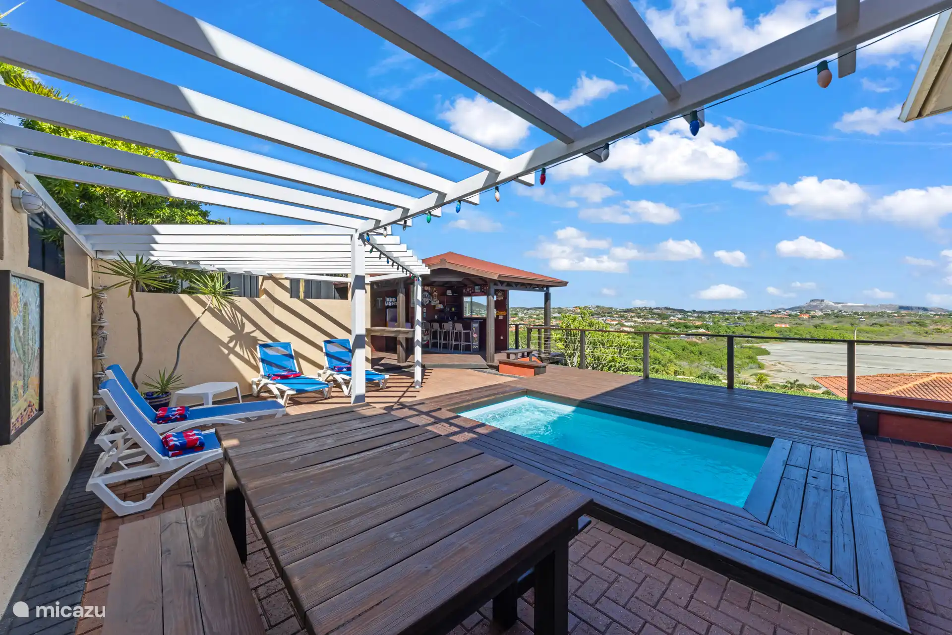 Sfeervol terras met plunge pool, ligbedden en een prachtig uitzicht — de ideale plek om te ontspannen en af te koelen.