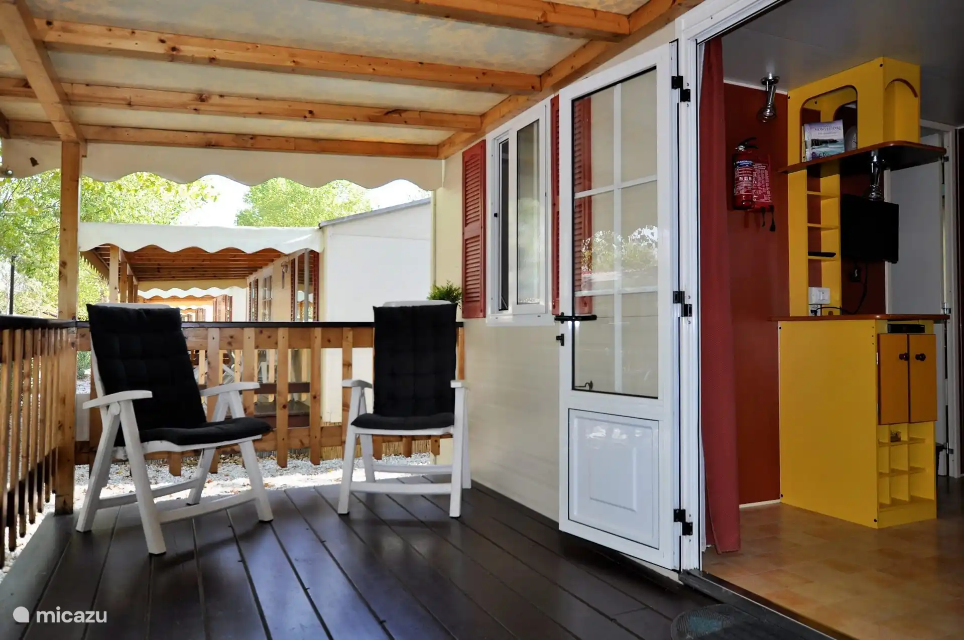 Cozy, covered veranda with comfortable chairs