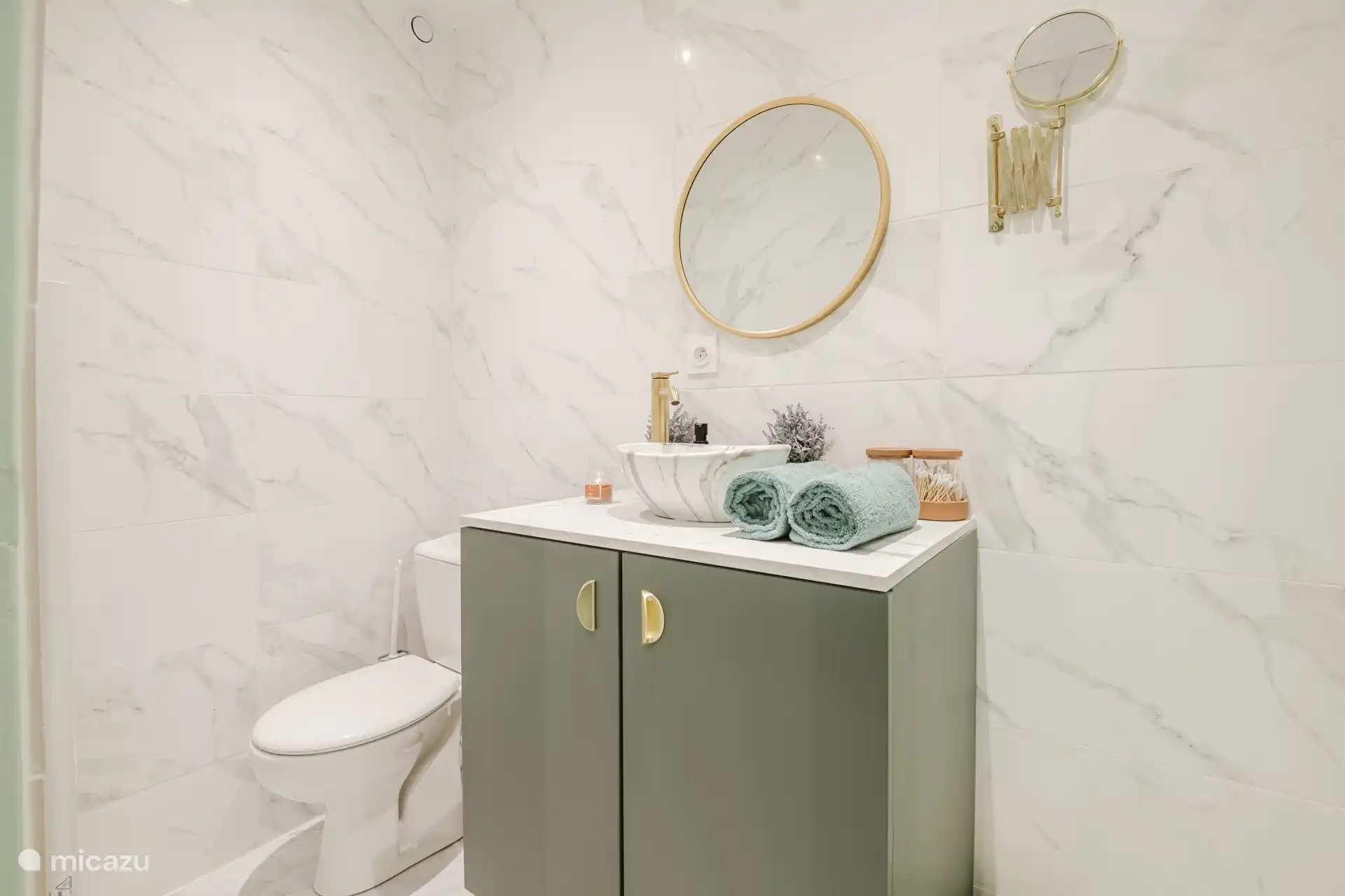 Toilet area with individual bath towels provided for each traveller.