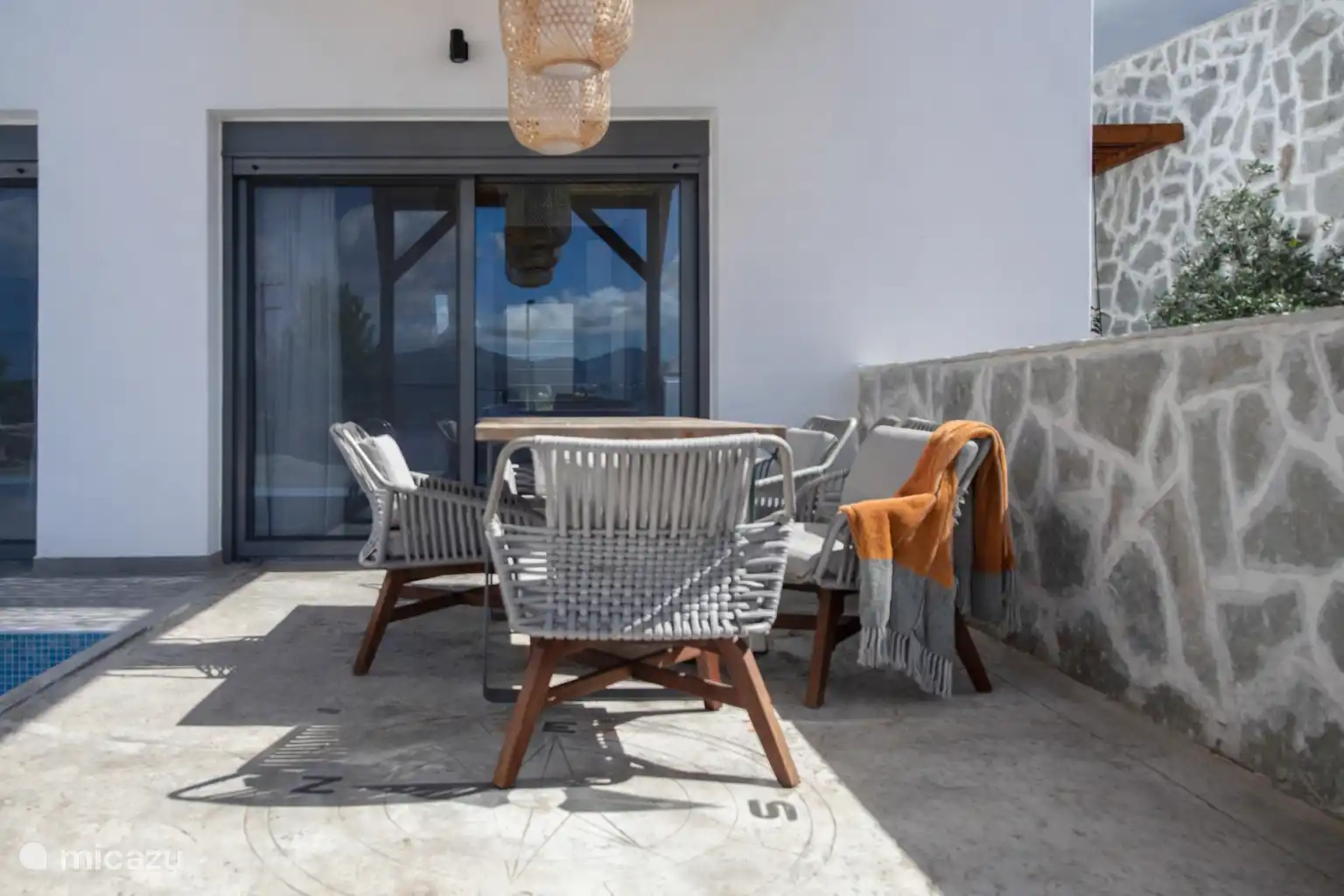outside dining table next to the pool 