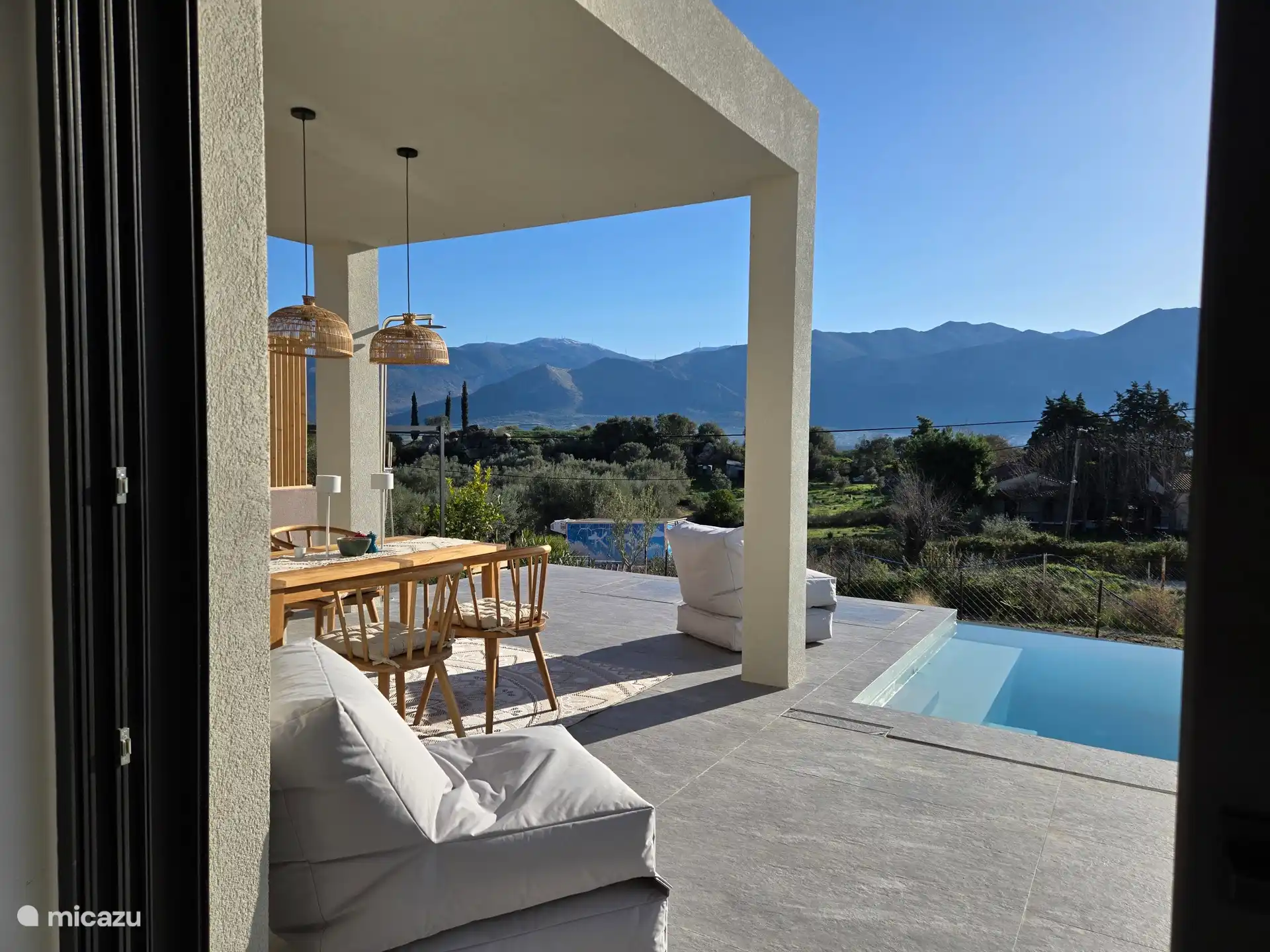 Blick aus dem Wohnzimmer auf das Becken, Meer und Berge 