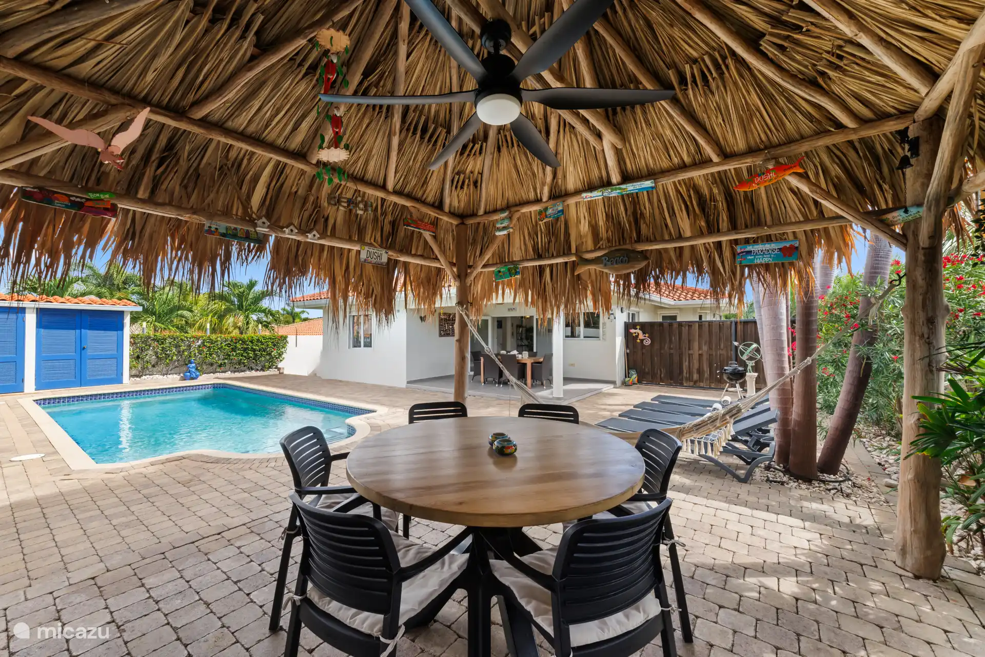 Shaded palapa next to the pool. Beach beds are also available for sunbathing.