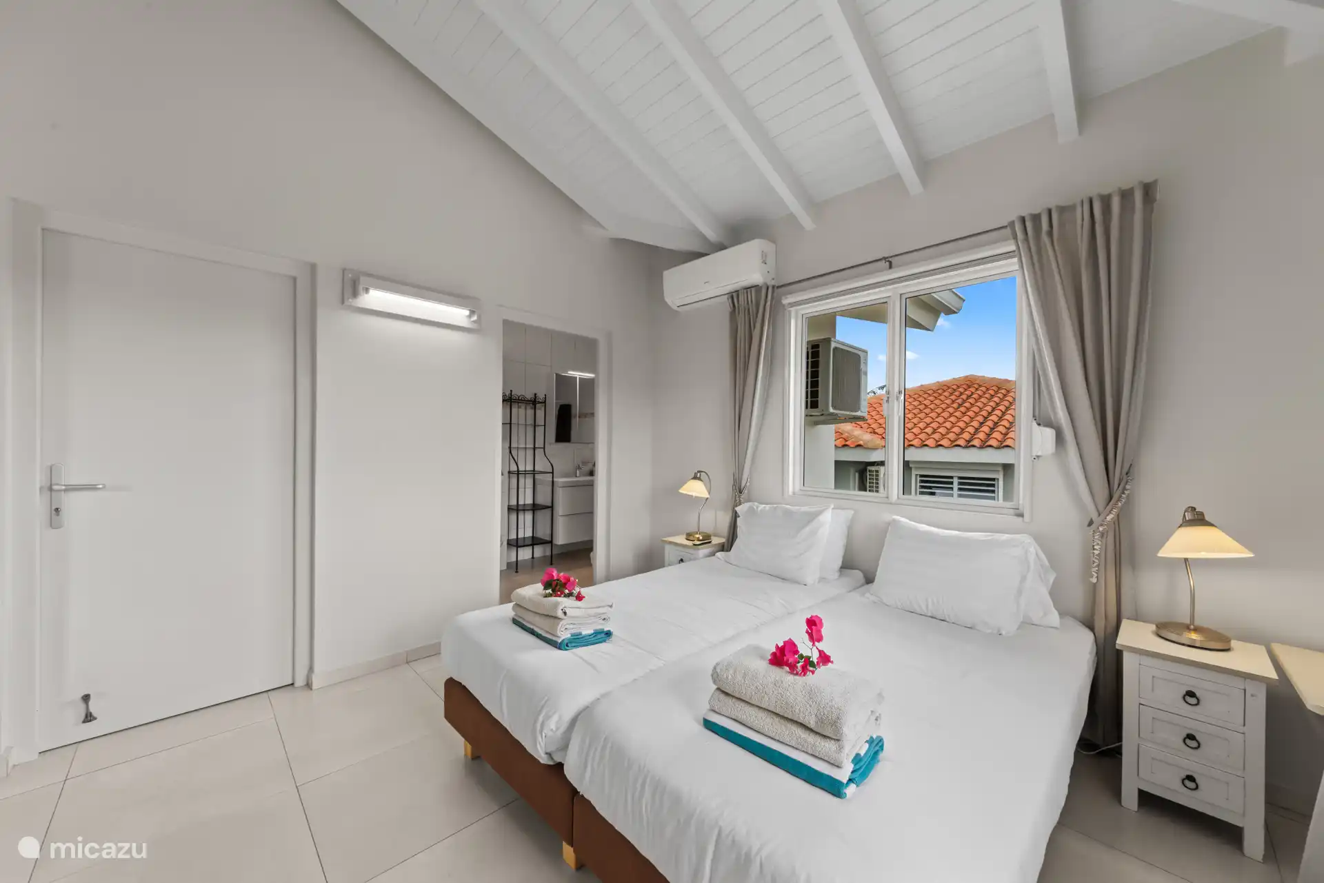 Master bedroom with air conditioning, wardrobe and private bathroom.