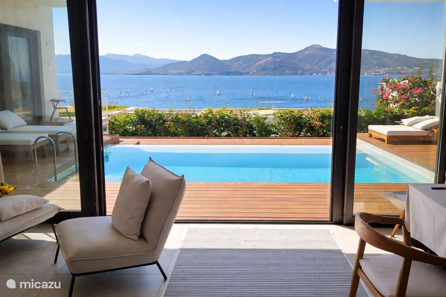 Vue sur la mer dans le salon, avec tous les voiliers sortis pour profiter de la brise de l’après-midi 