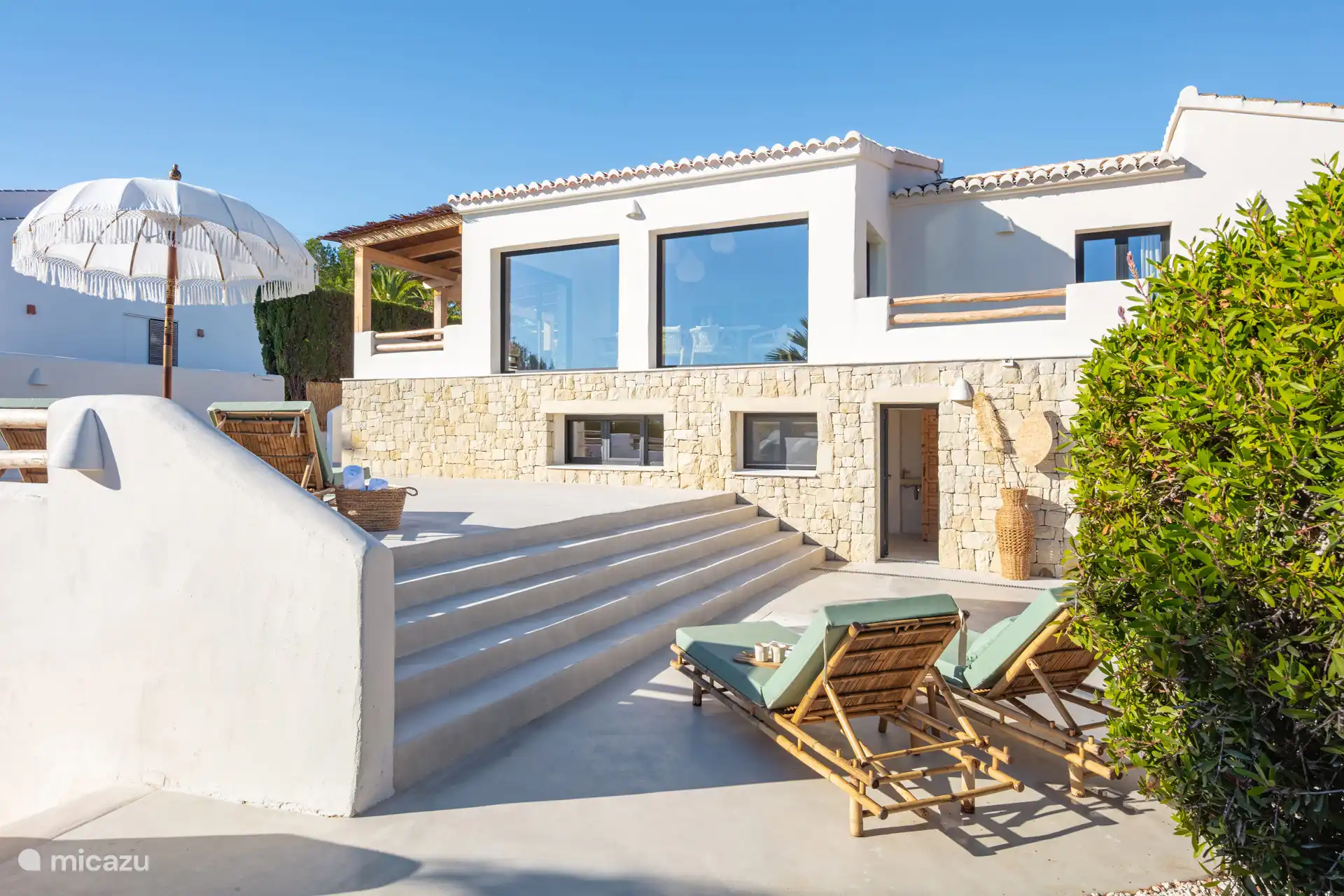 Impressie huis met terras lager gelegen.