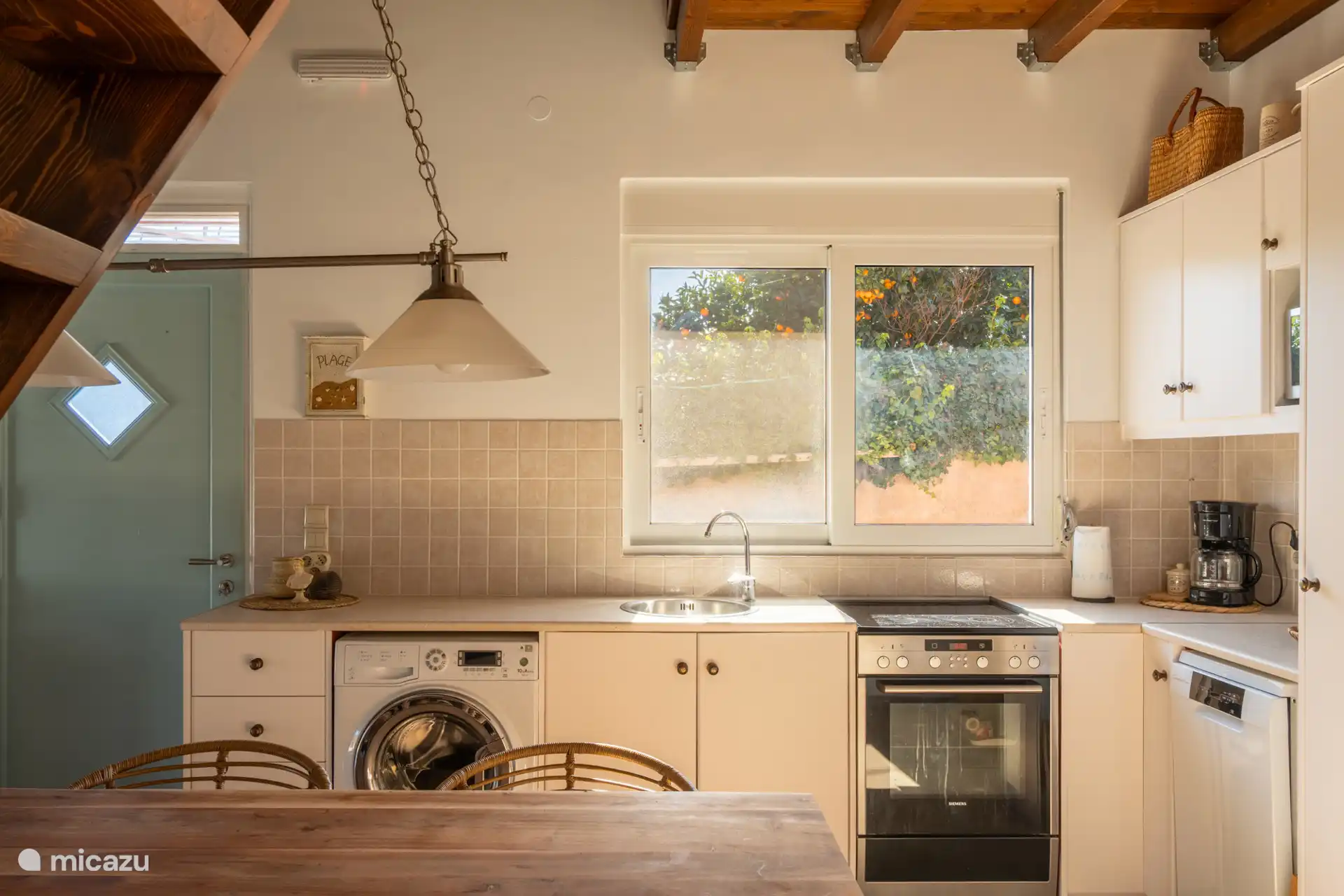 Kitchen with all conveniences, including washing machine, oven and dishwasher