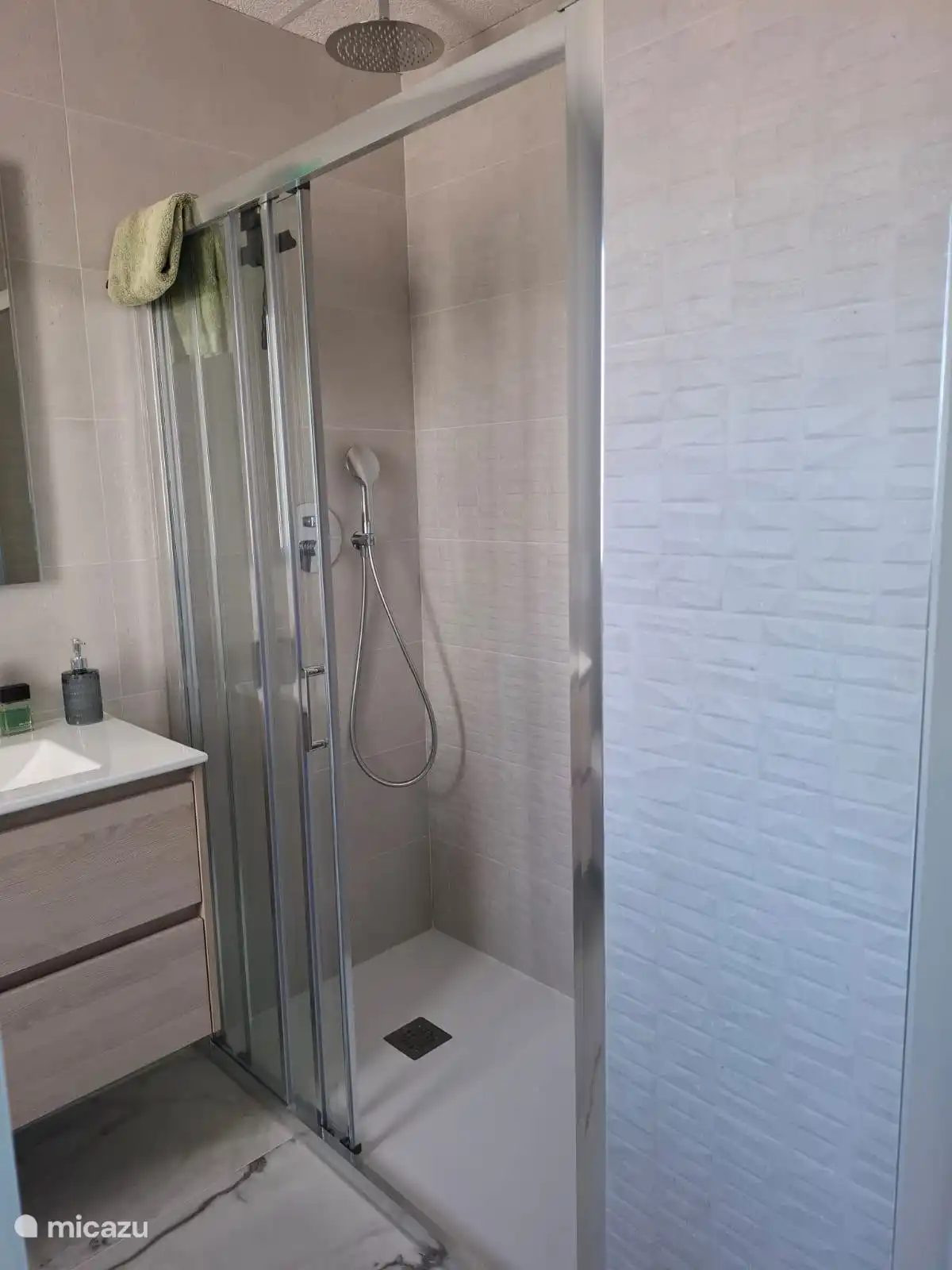 spacious rain shower in the ensuite bathroom belongs to the master bed room 