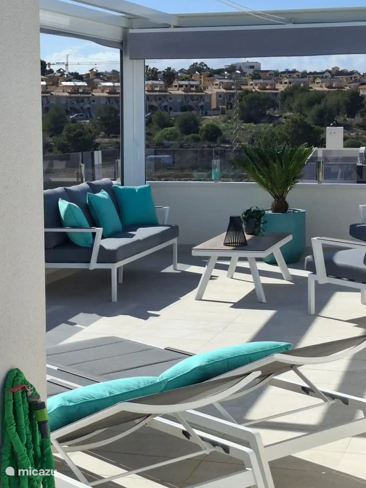 lovely relax lounge sofa overlooking the communal swimming pool and the apartment complex