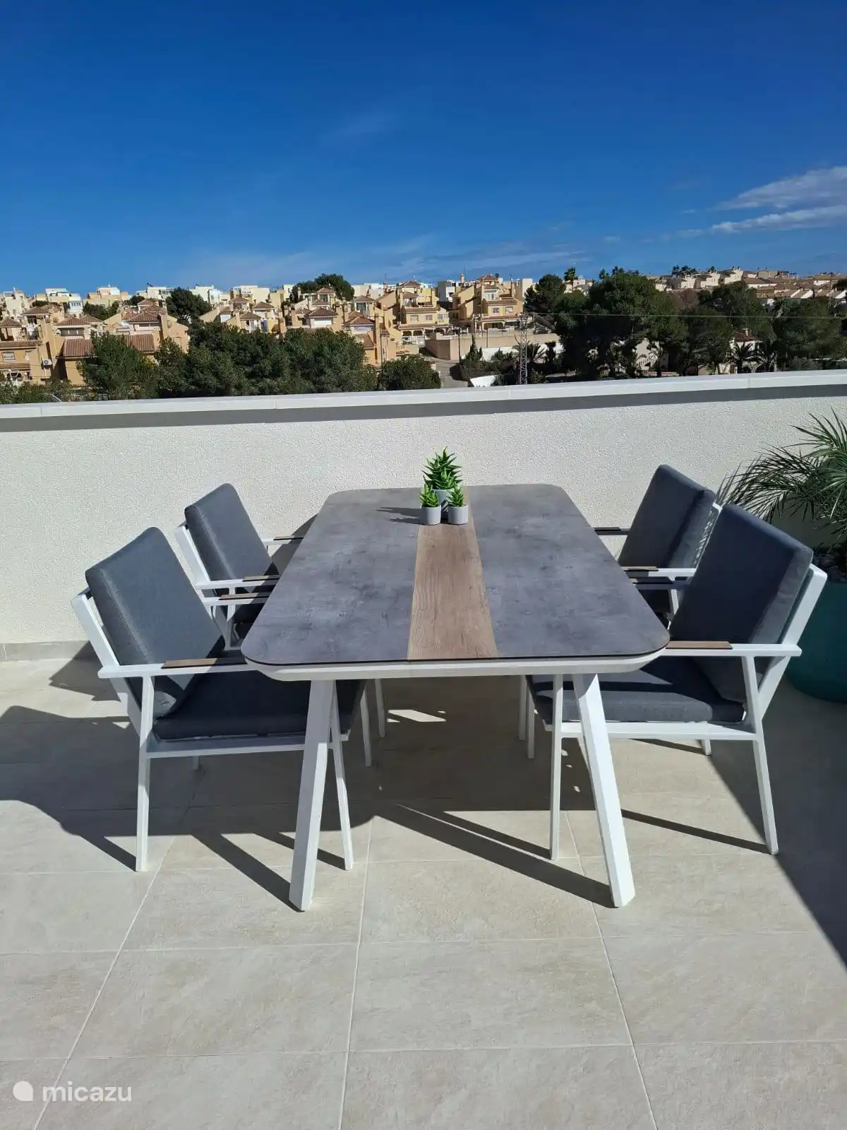 a dining table with 4 chairs present enjoying a delicious meal on with a cup of coffee in the morning