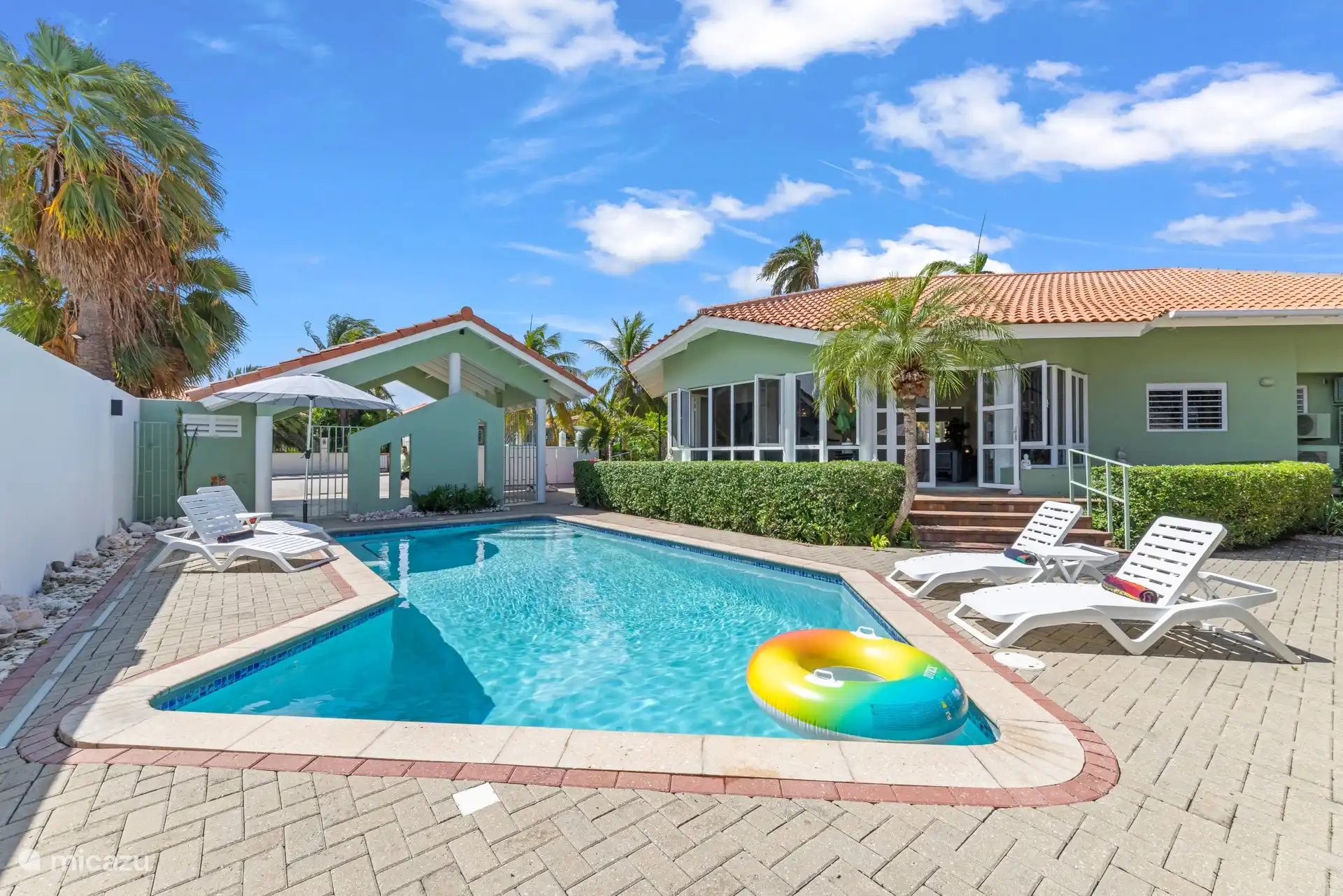 Een lang, zonovergoten zwembad met volop ruimte voor ochtendbaantjes, drijven en middagcocktails bij het water.