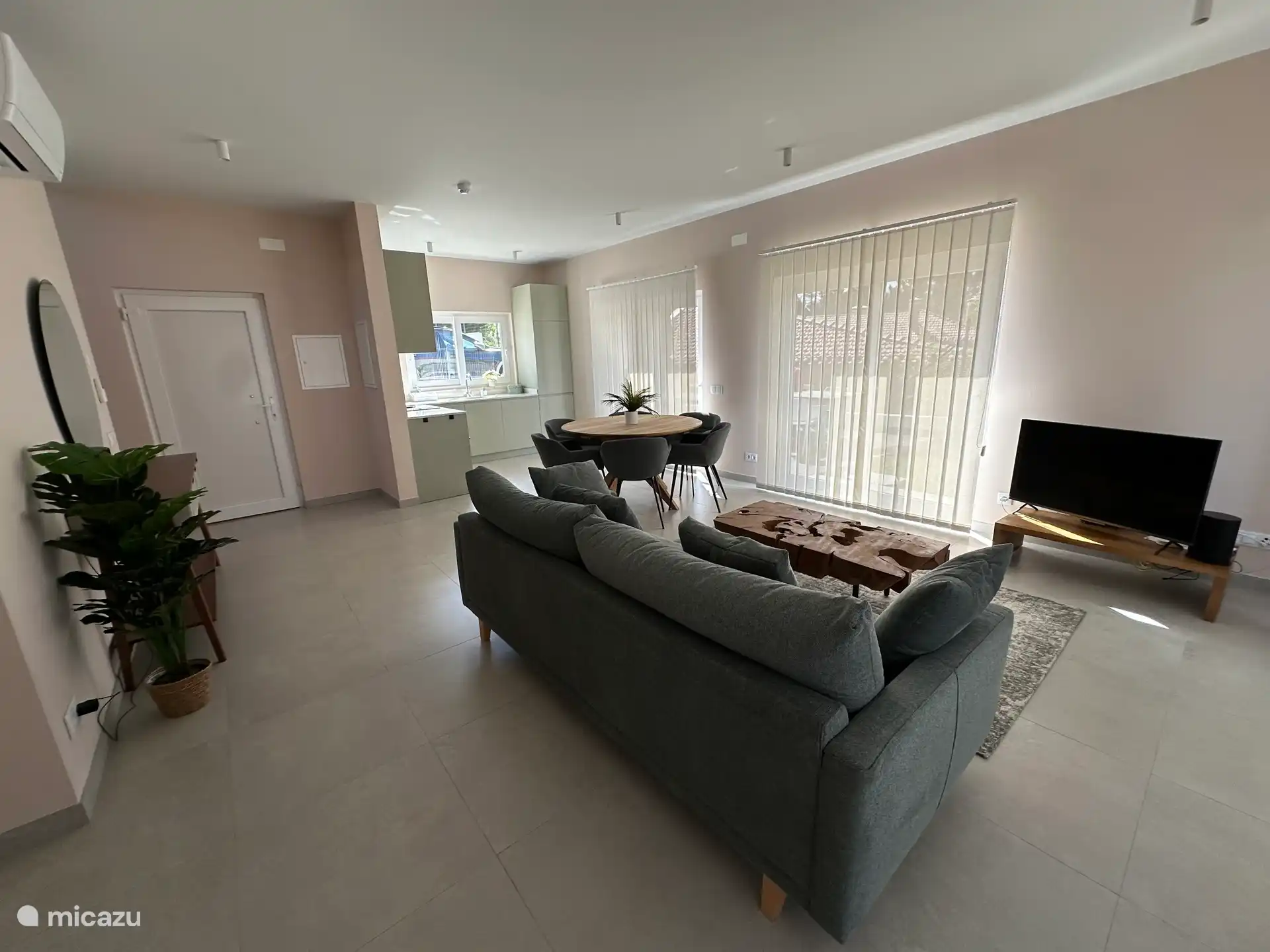 Een ruime living met zithoek en eettafel voor 6.