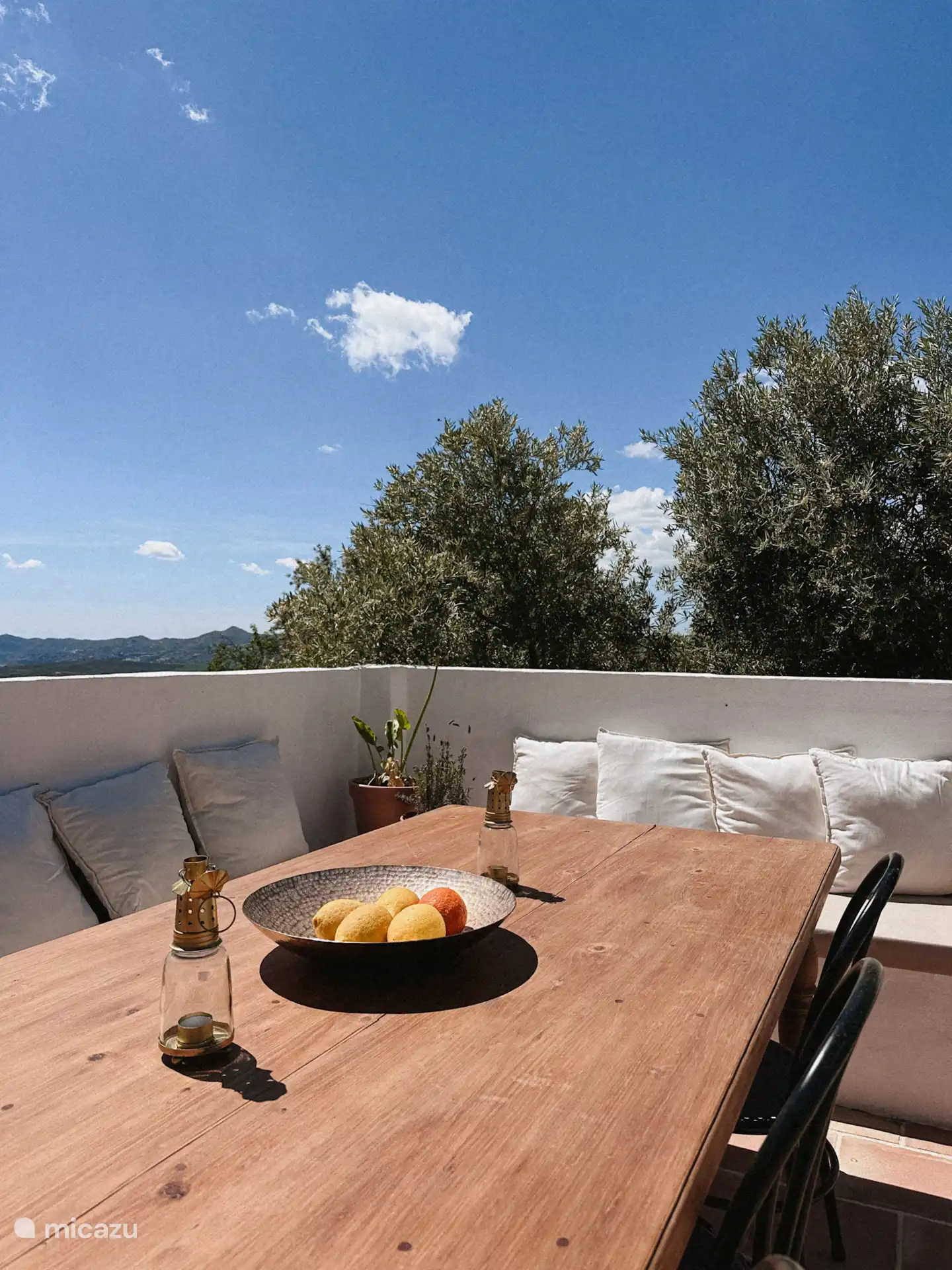 De eethoek op het terras bij het zwembad. In de buitenkeuken staat een bbq voor algemeen gebruik en is een koelkast met drankjes (honesty bar)