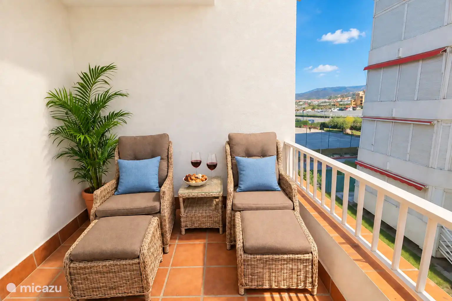 The same balcony, with two lounge chairs on the other side.