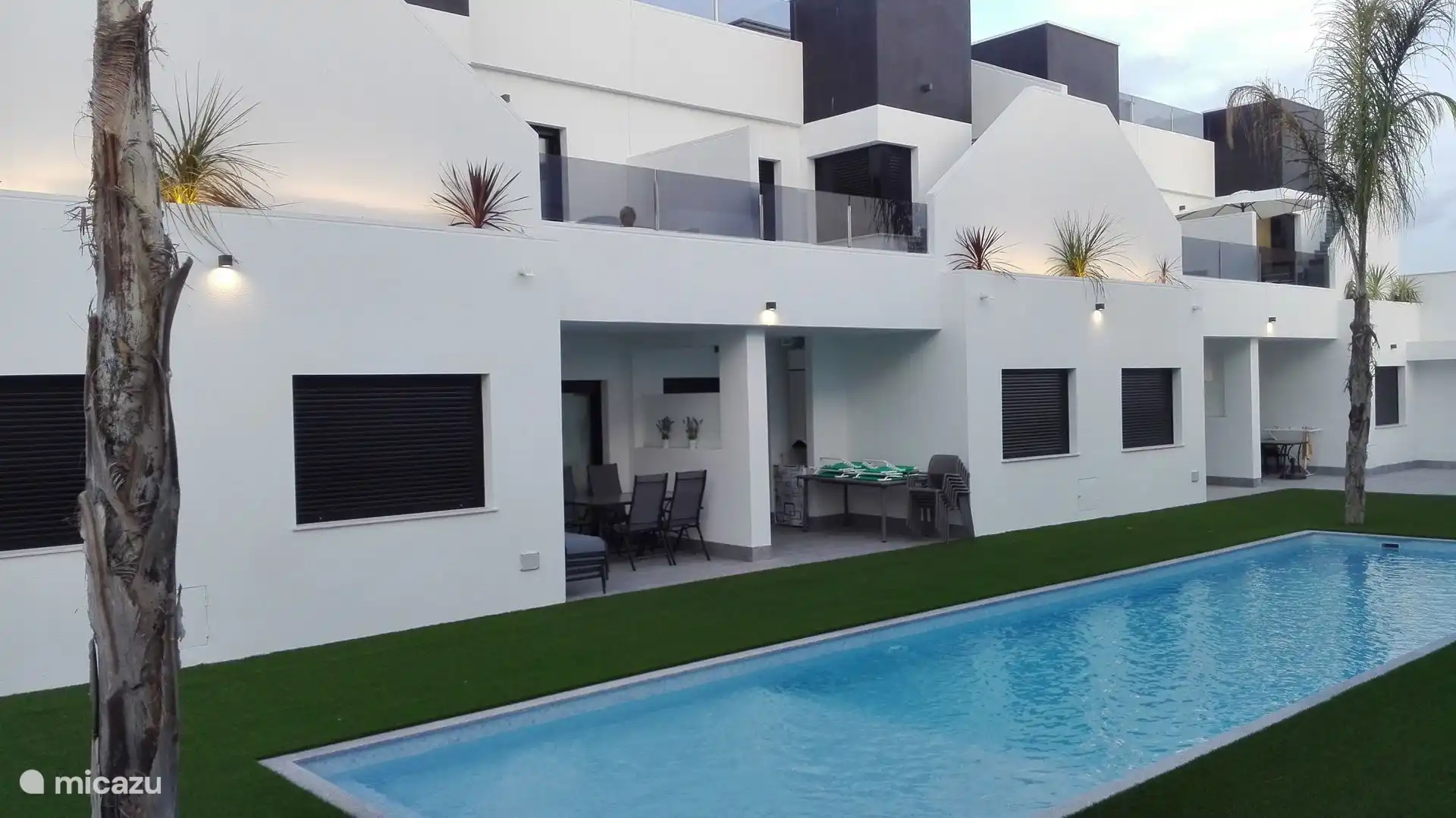 View of apartment terrace from the pool area.