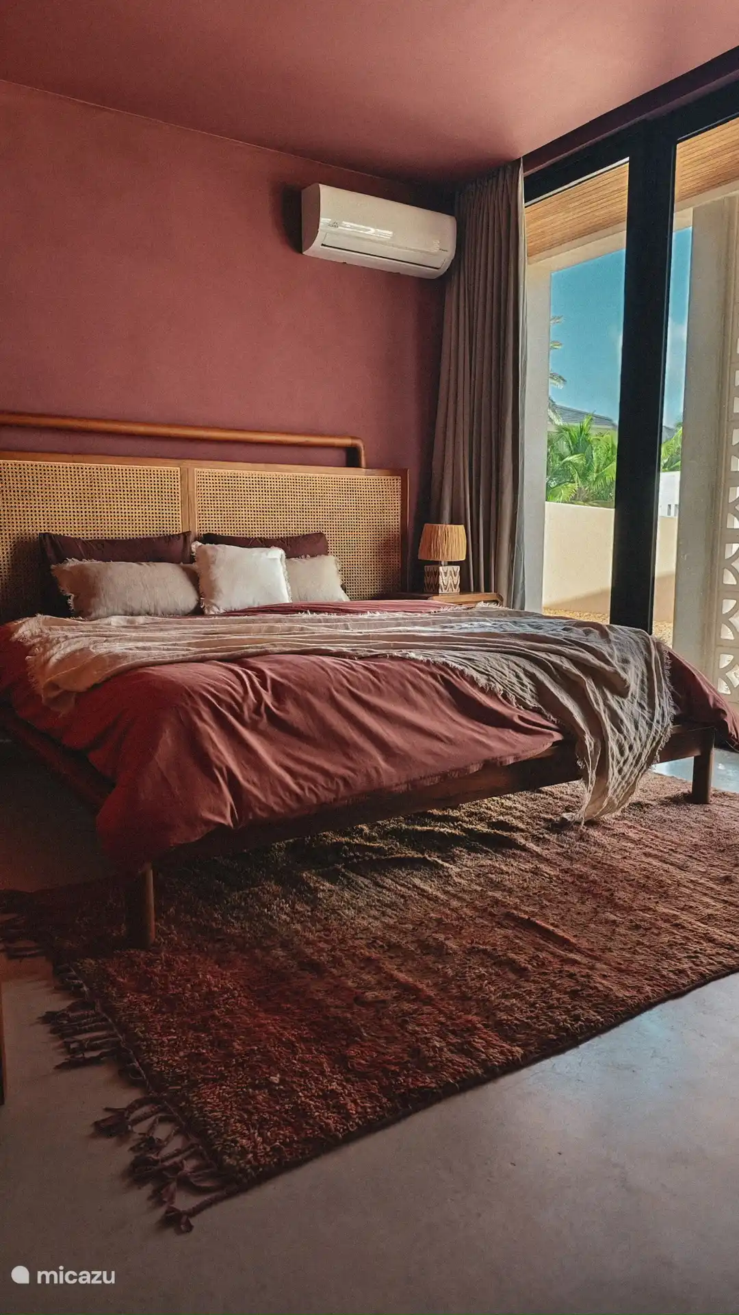 Bedroom in main house with outdoor seating and ensuite bathroom.