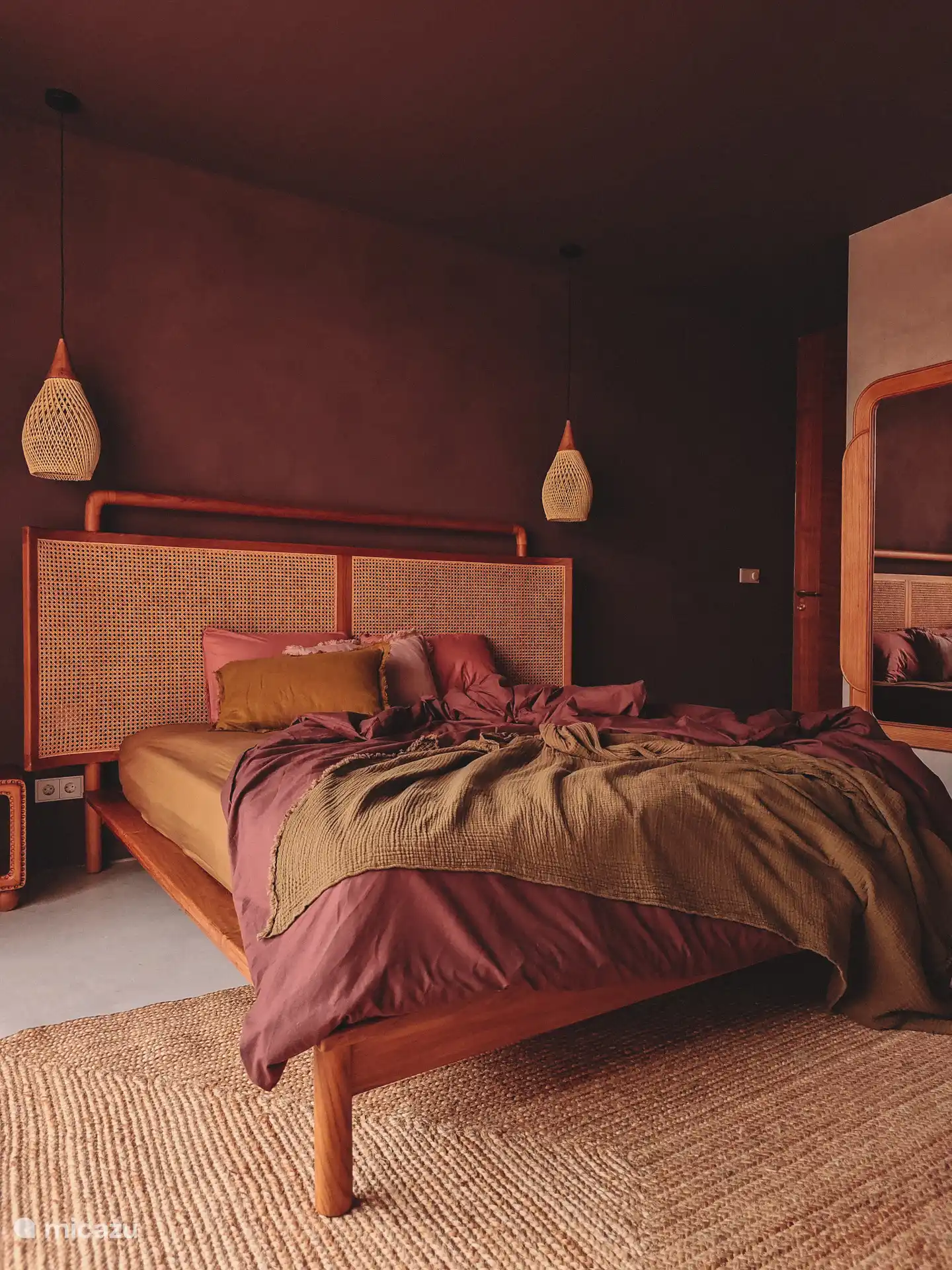 Master bedroom in deep aubergine tones, king size teak bed.