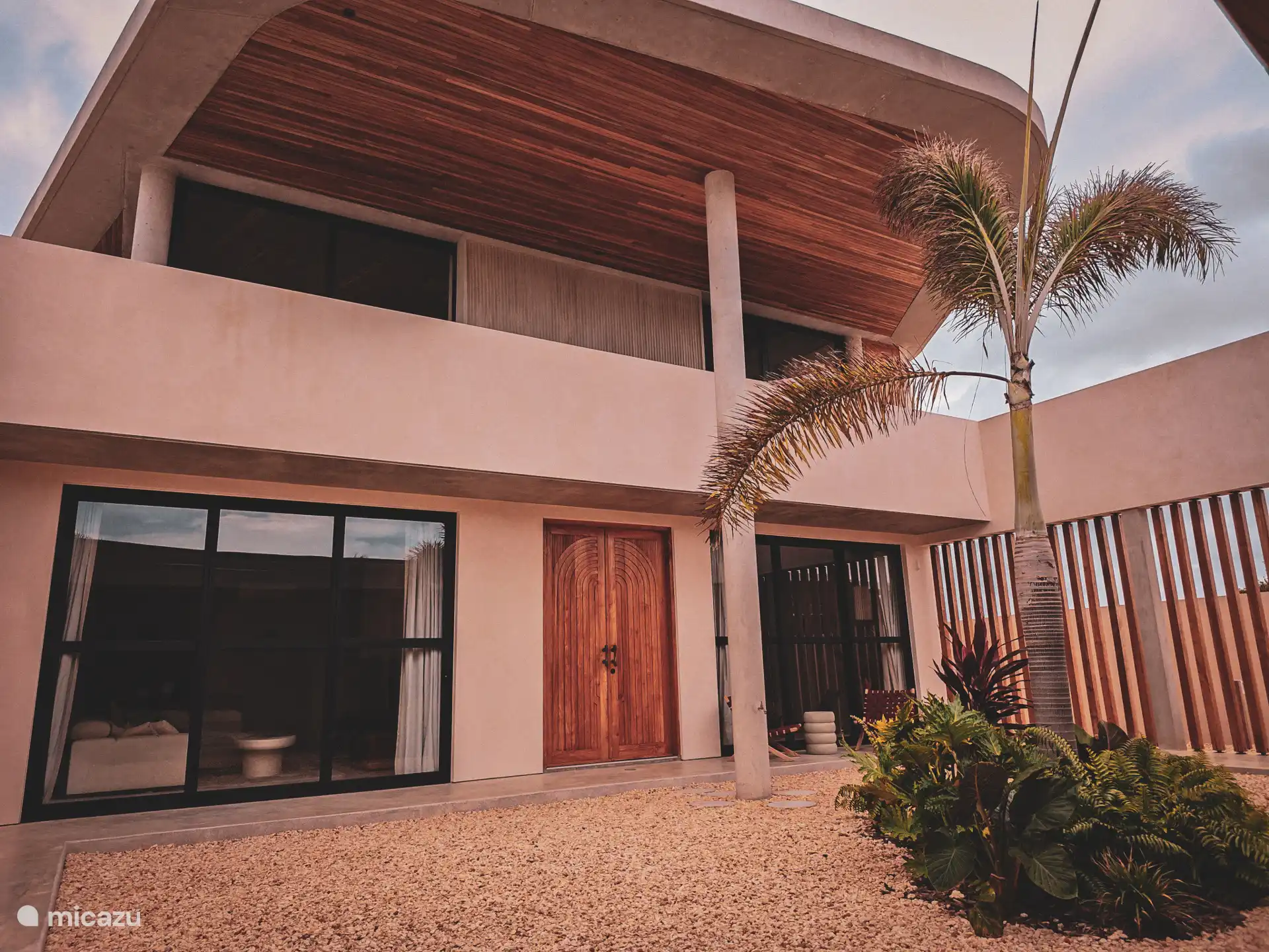 Courtyard garden with the media room to the left of the main entrance and the master bedroom to the right.