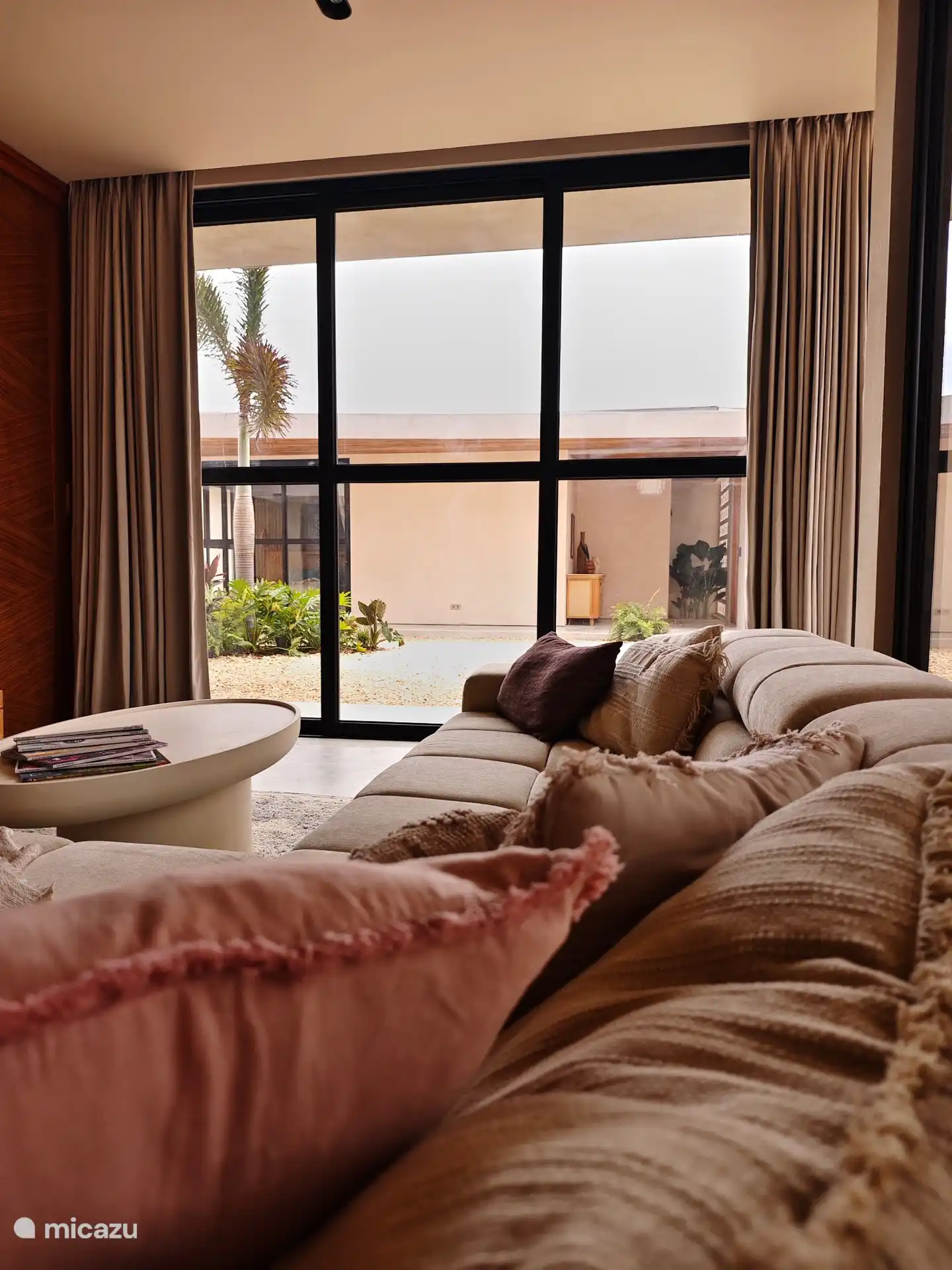 Media room with sliding doors opening onto the courtyard garden.