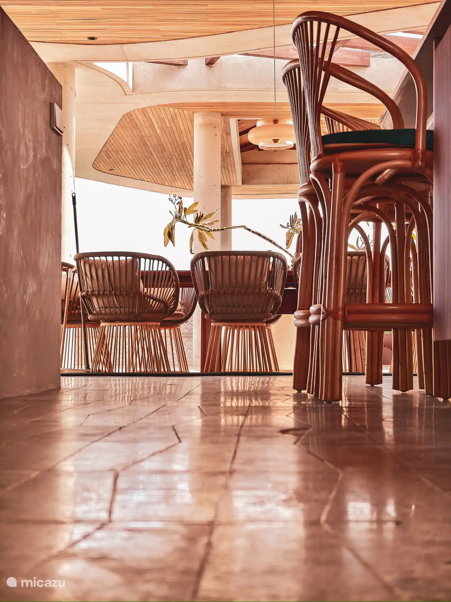 View from the bar stools on the kitchen island towards the dining table on the terrace.