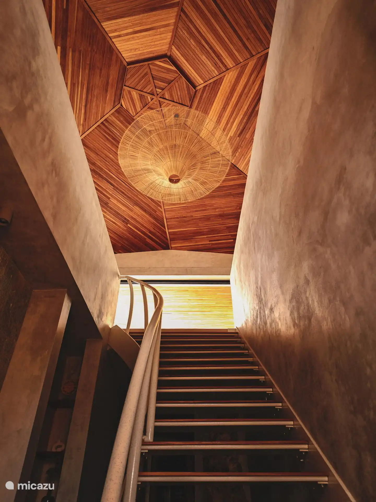 Stairs to the 1st floor where the swimming pool, terrace, living room and kitchen are located.