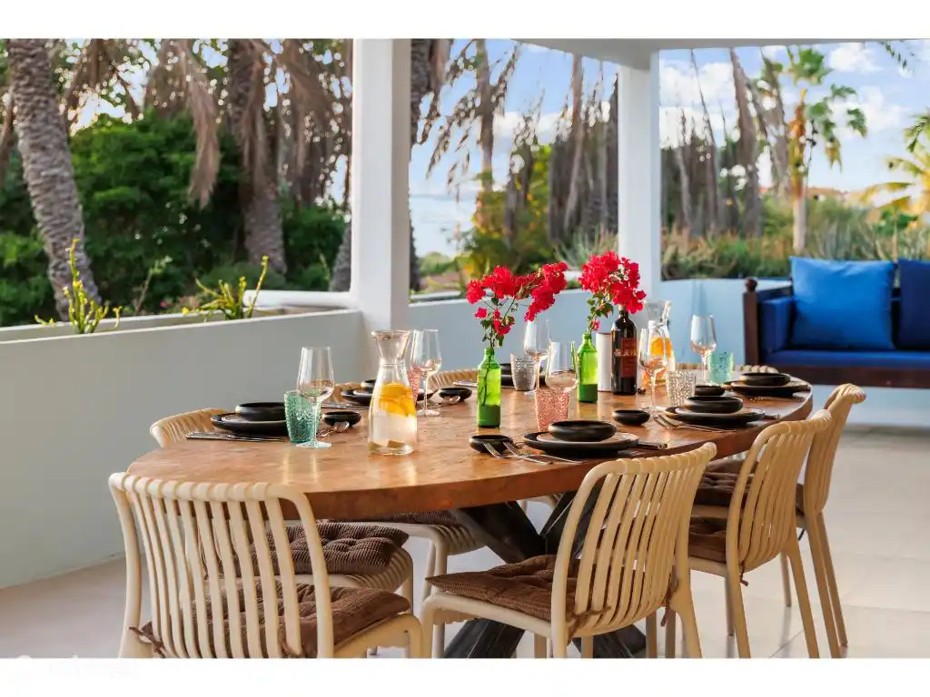 Lovely large dining table on the front porch, with sea view