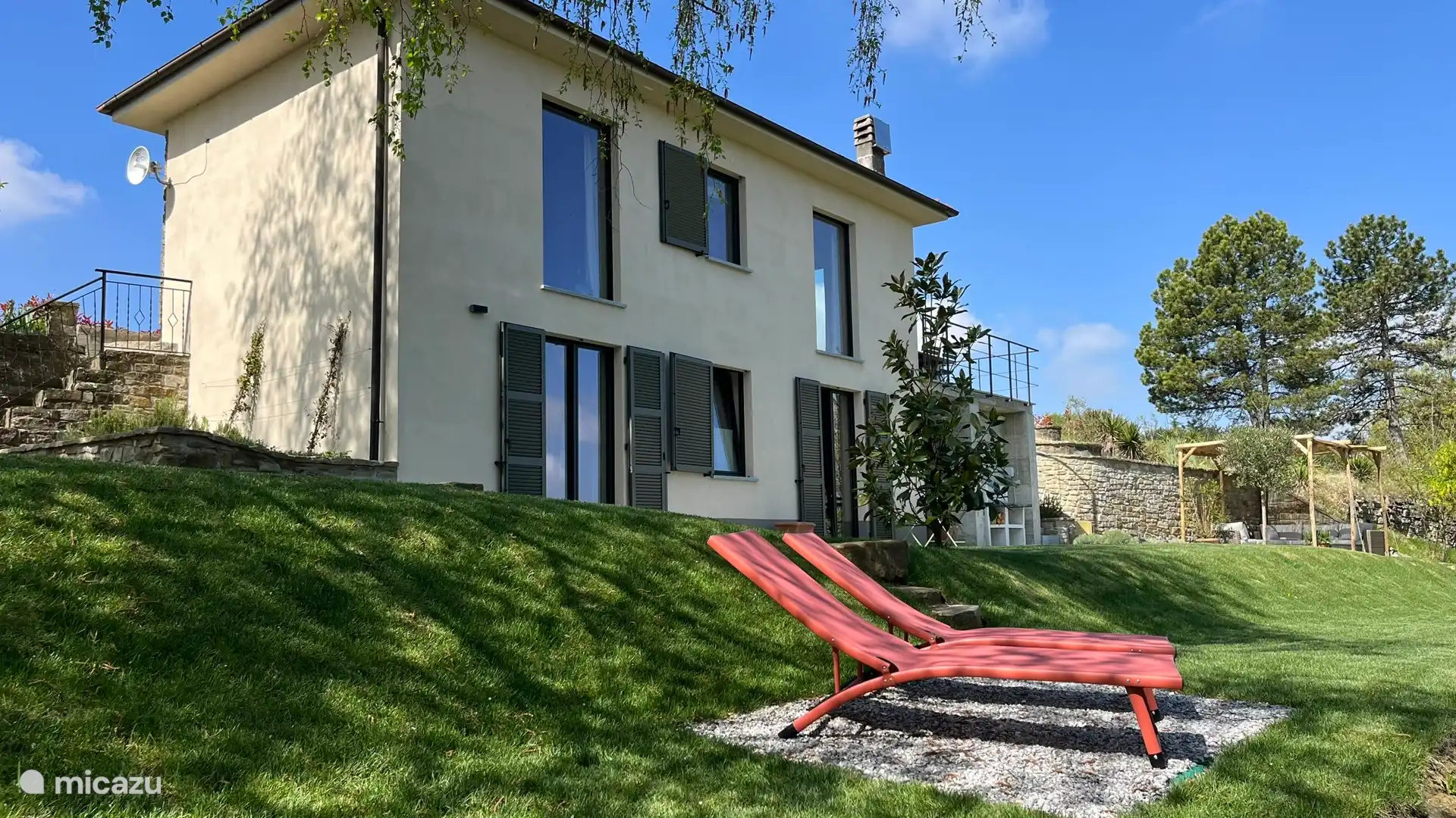 The house is built against a hill.  Upstairs at street level is the living/dining kitchen and downstairs are the bedrooms and bathroom.