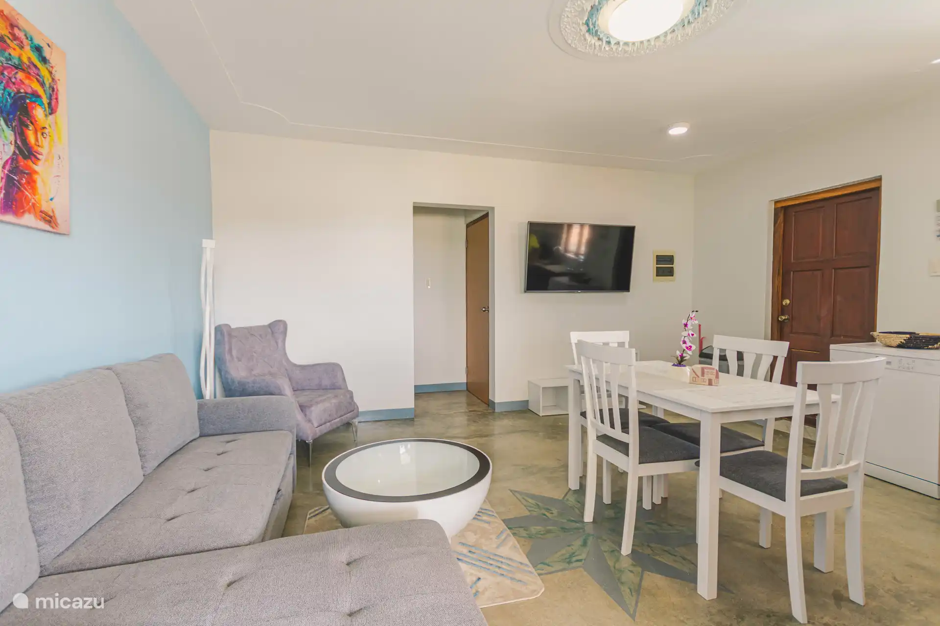 A 3 person sofa with a TV to watch Netflix and various international programs 
