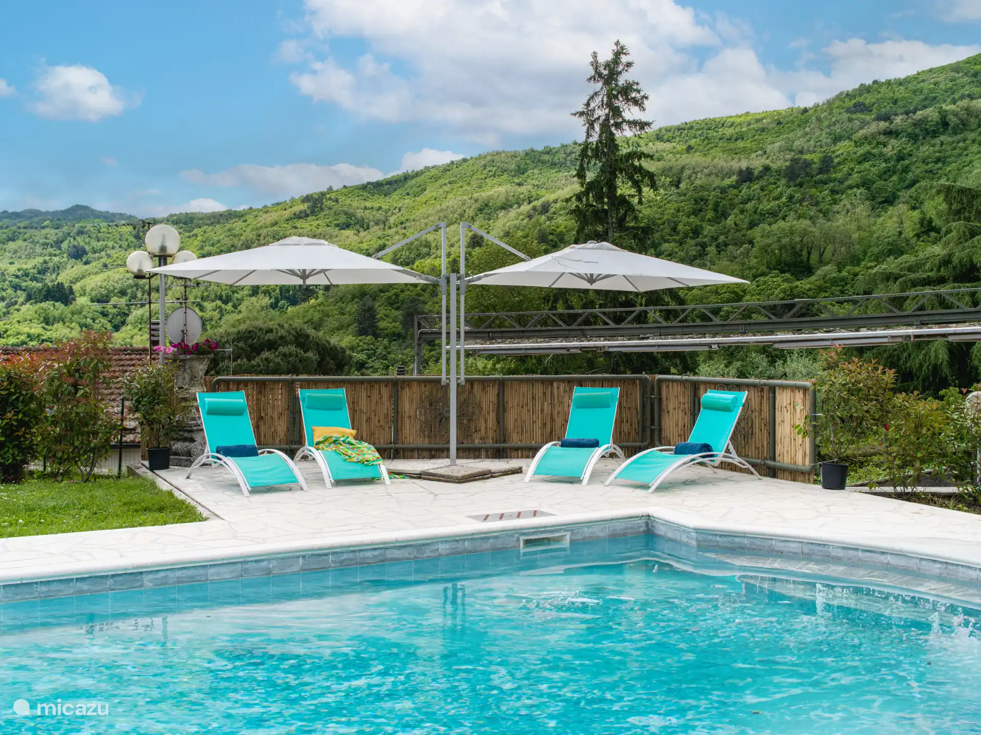 Swimming pool with sun loungers