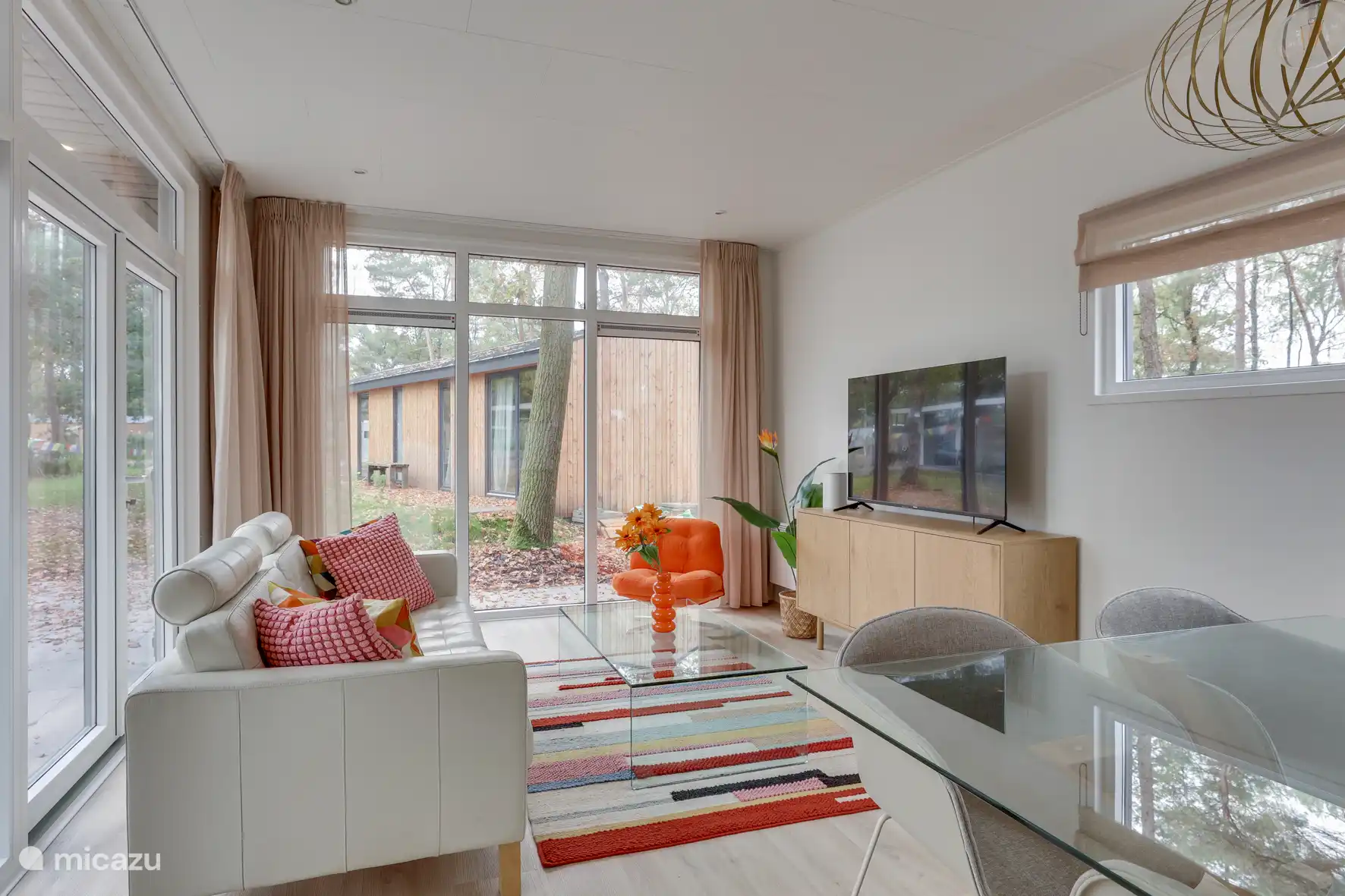 The spacious living room with large widescreen TV, 2.5 seater sofa and lounge chair