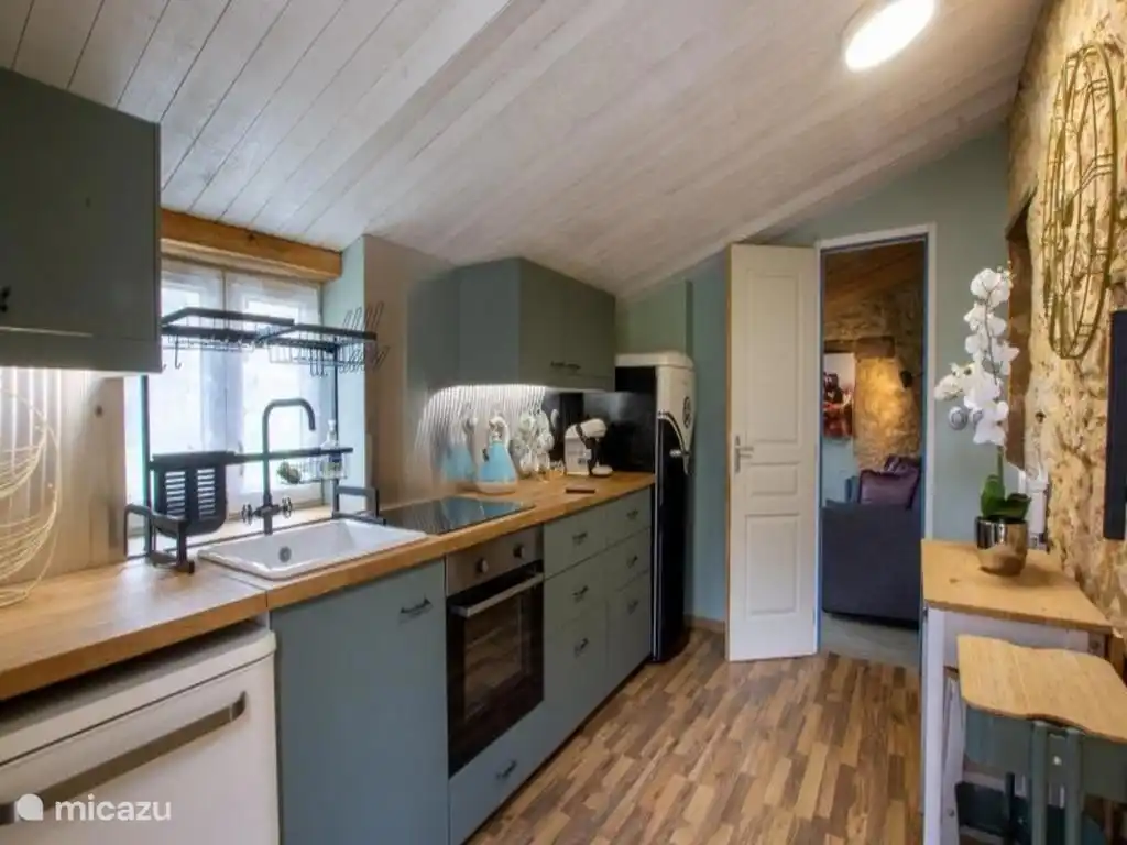 Volledig uitgeruste keuken in een klein huisje. 
De lounge is rechtdoor
De ingangen naar zowel de slaapkamer als de badkamer zijn aan de rechterkant