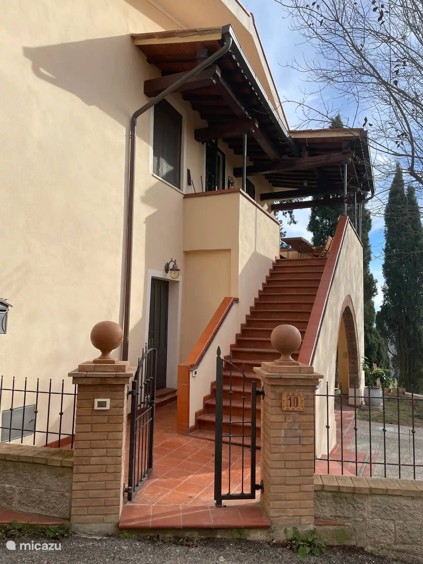 The stairs to the 1st floor and the entrance to the apartment on the ground floor.