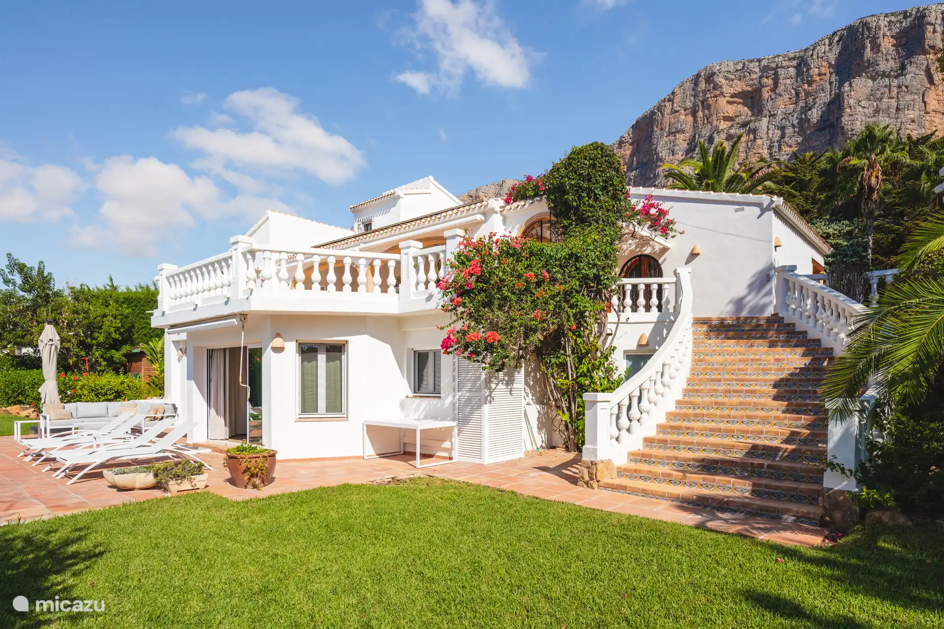 Side view house with Spanish stairs to terrace upstairs.
