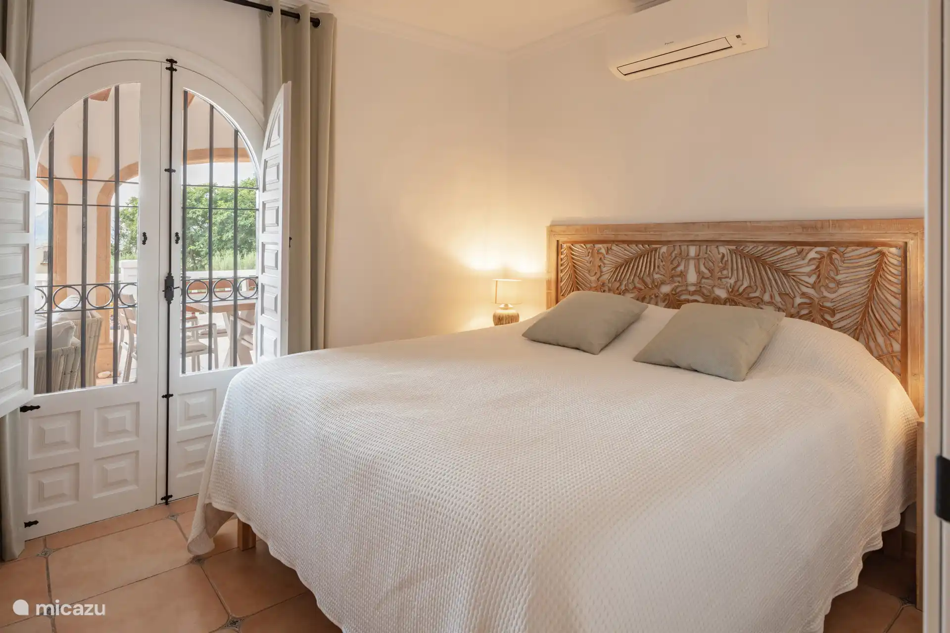 Bedroom adjacent to terrace with French doors.